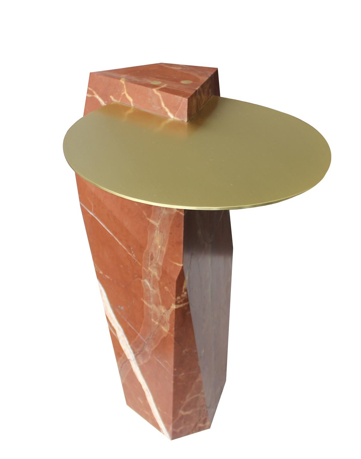 A solid block of Rosso Collemandina marble, quarried in Tuscany, carved and inset with a solid brass tray. Available in a variety of colored marbles and numerous metal options. Can also be made as a dining or console table.