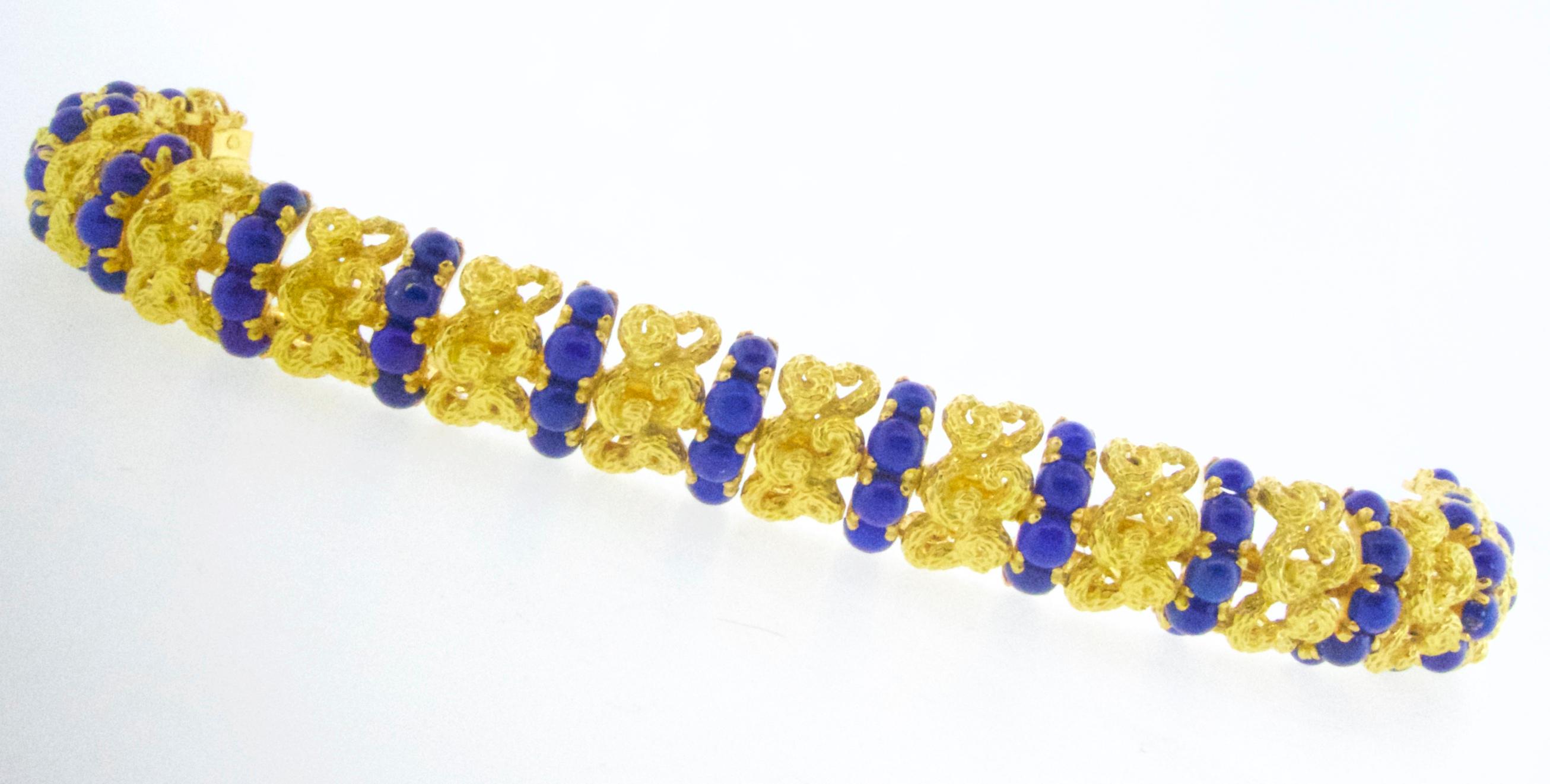 18K yellow gold weighing 87.47 grams and possessing 45 natural lapis stones prong set.  The fine Persian lapis is a vivid deep blue  and well matched.  This bracelet, in fine condition, is seven inches long and does have the maker's mark, a horse