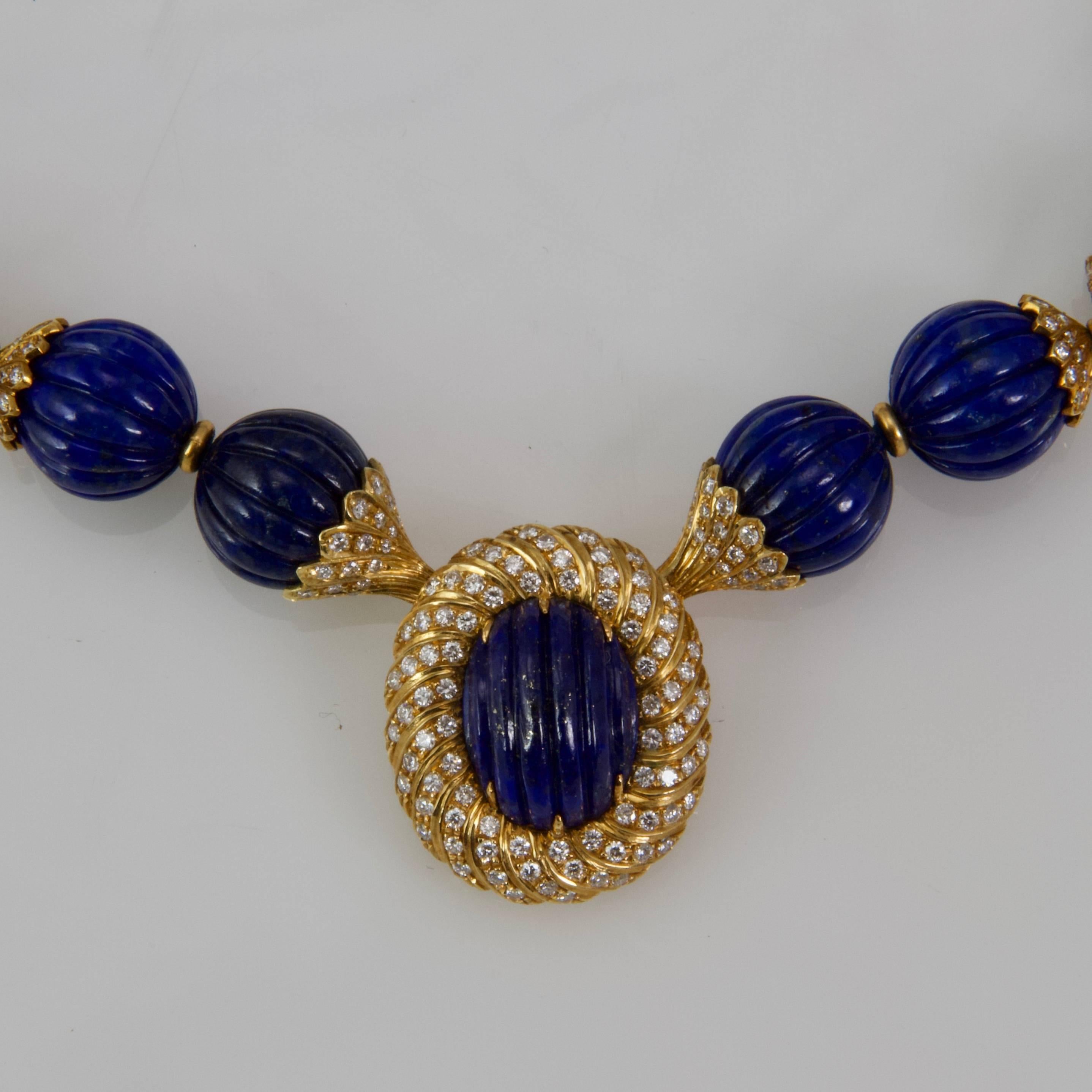 33 engraved watermelon shape lapis lazuli necklace, yellow gold interlayer which six are set with round diamonds as well as central oval pattern pendant. 
Signed by the great italian jeweller Missaglia. 
18kt yellow gold
Made around 1970
Lapis pearl