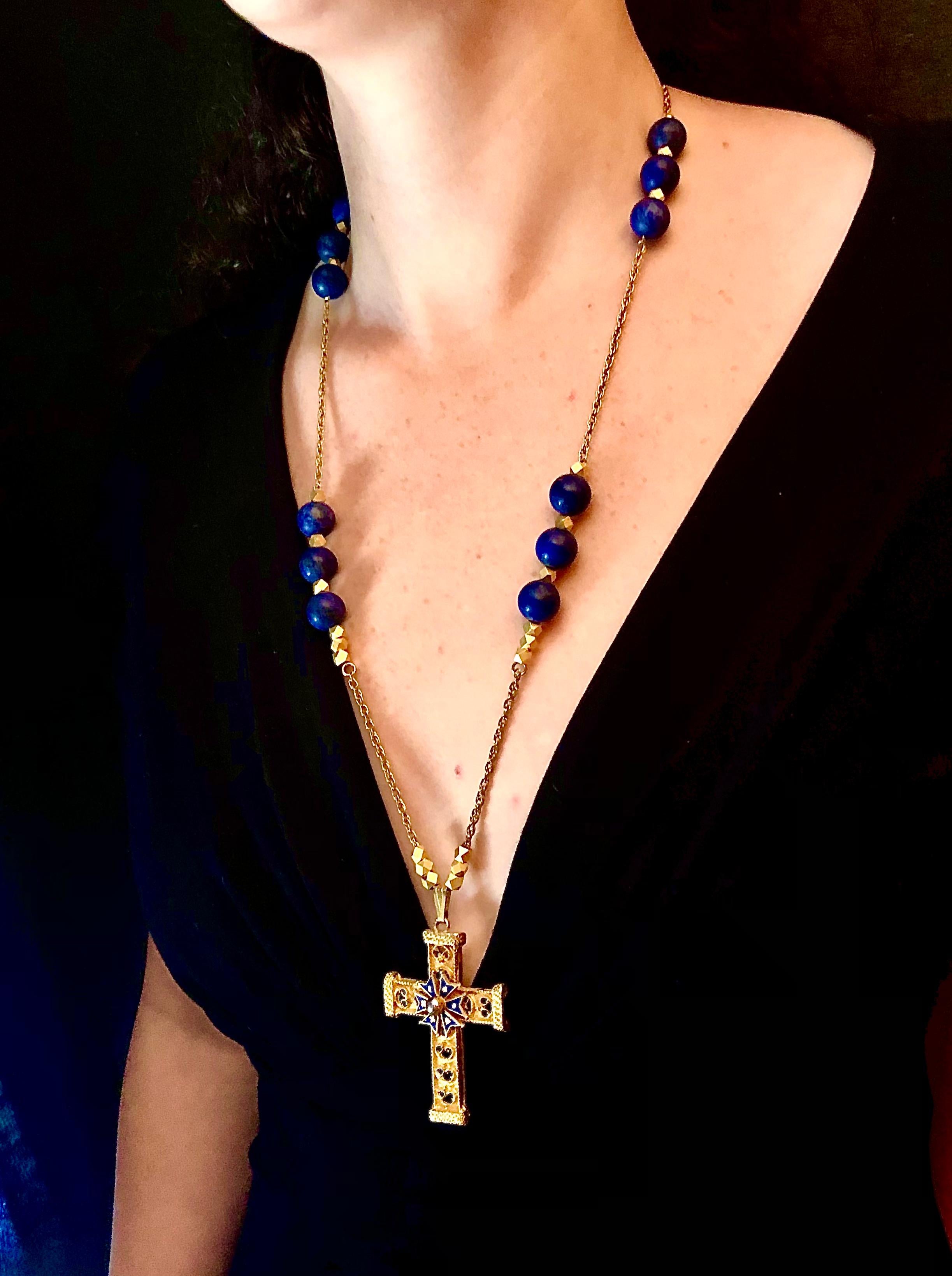 Vintage fashion jewel crucifix in medieval taste with enameled St. Andrew s cross in center.

The vintage cross has been suspended from a new chain in an adaptation of a rosary form with matte lapis lazuli beads and angular form gilt metal spacer
