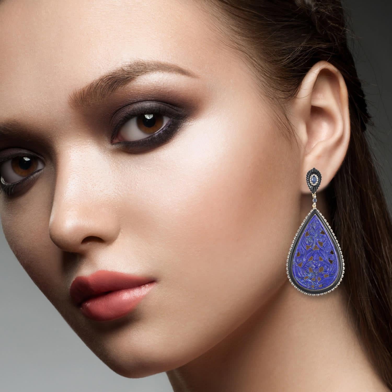 Cast in 18-karat gold & sterling silver, these beautiful drop earrings are set with 62.24 carats lapis, 16.63 carats black onyx, .68 carats blue sapphire and 1.14 carats of sparkling diamonds. 

FOLLOW  MEGHNA JEWELS storefront to view the latest