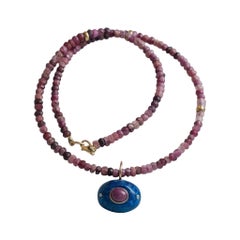 Malocchio di Lapis con rubino e diamanti su una collana di perline di rubino con oro 14k