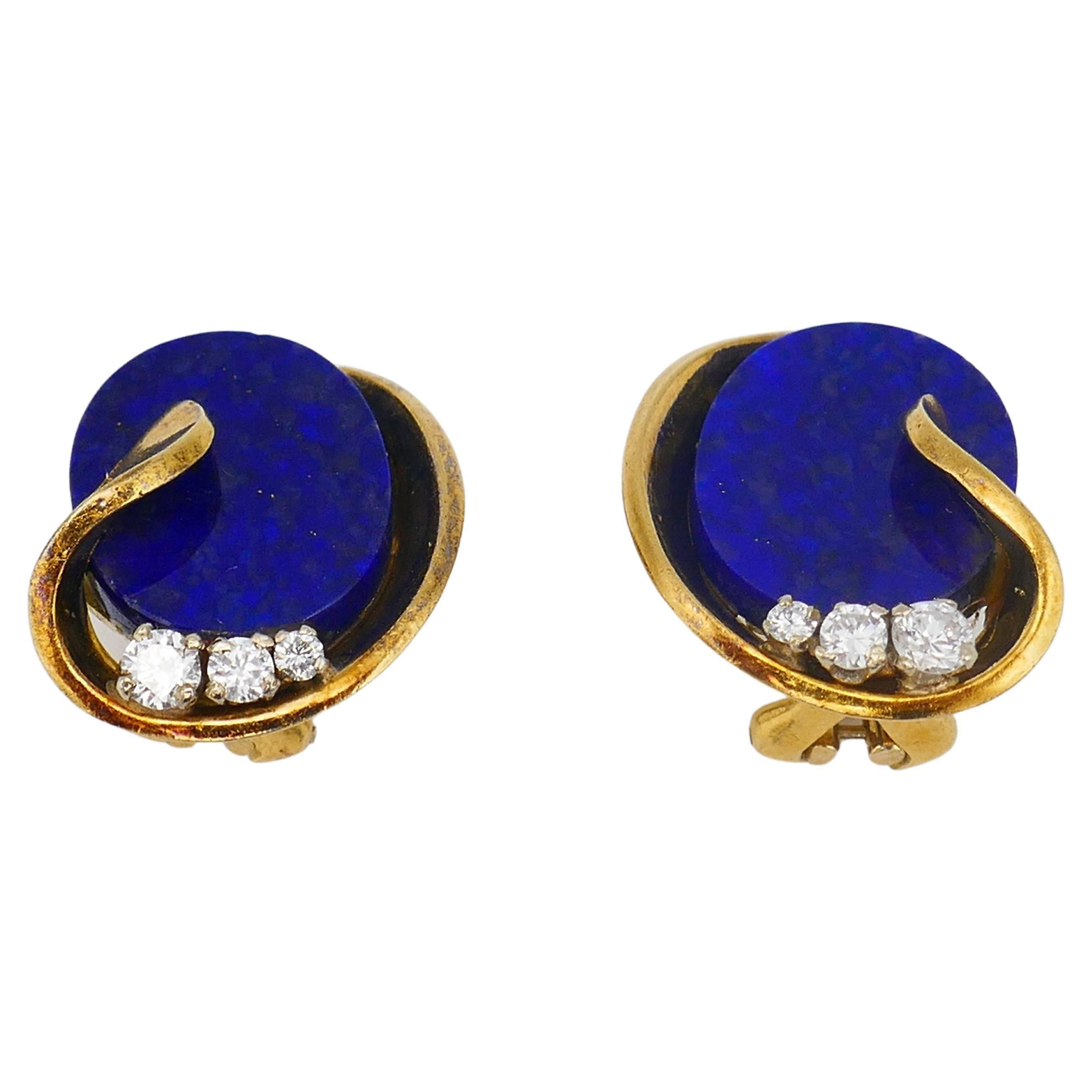 A pair of fine Vintage earrings, made of 18k gold and lapis, featuring diamond.
Bright yet delicate gold earrings with the oval shape flat lapis. The stone is beautifully framed in gold of leafy design. The bottom of the earrings is adorned with 3