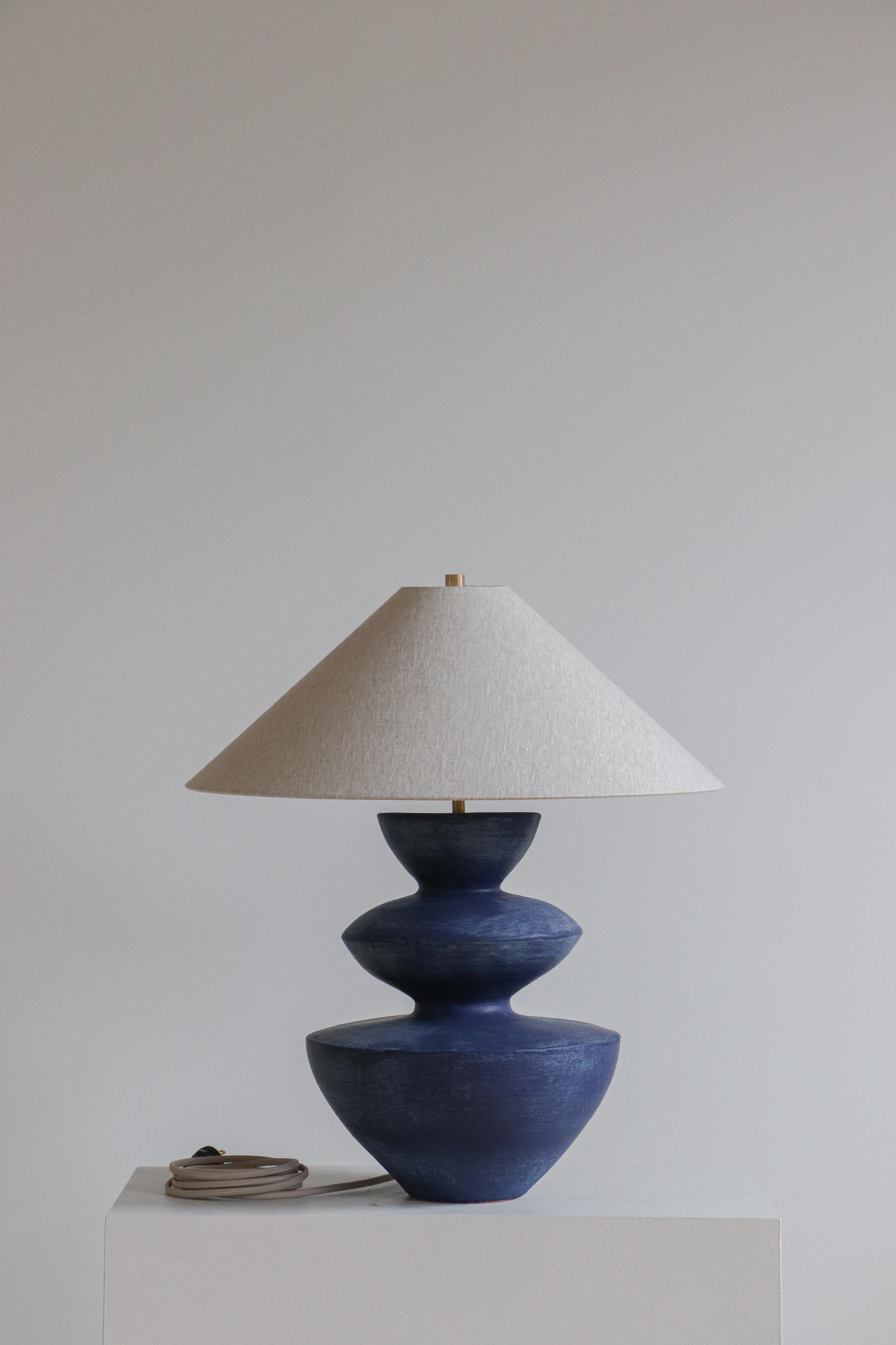 Lapis Janus Table Lamp by Danny Kaplan Studio
Dimensions: ⌀ 51 x H 59 cm
Materials: Glazed Ceramic, Unfinished Brass, Linen

This item is handmade, and may exhibit variability within the same piece. We do our best to maintain a consistent product,
