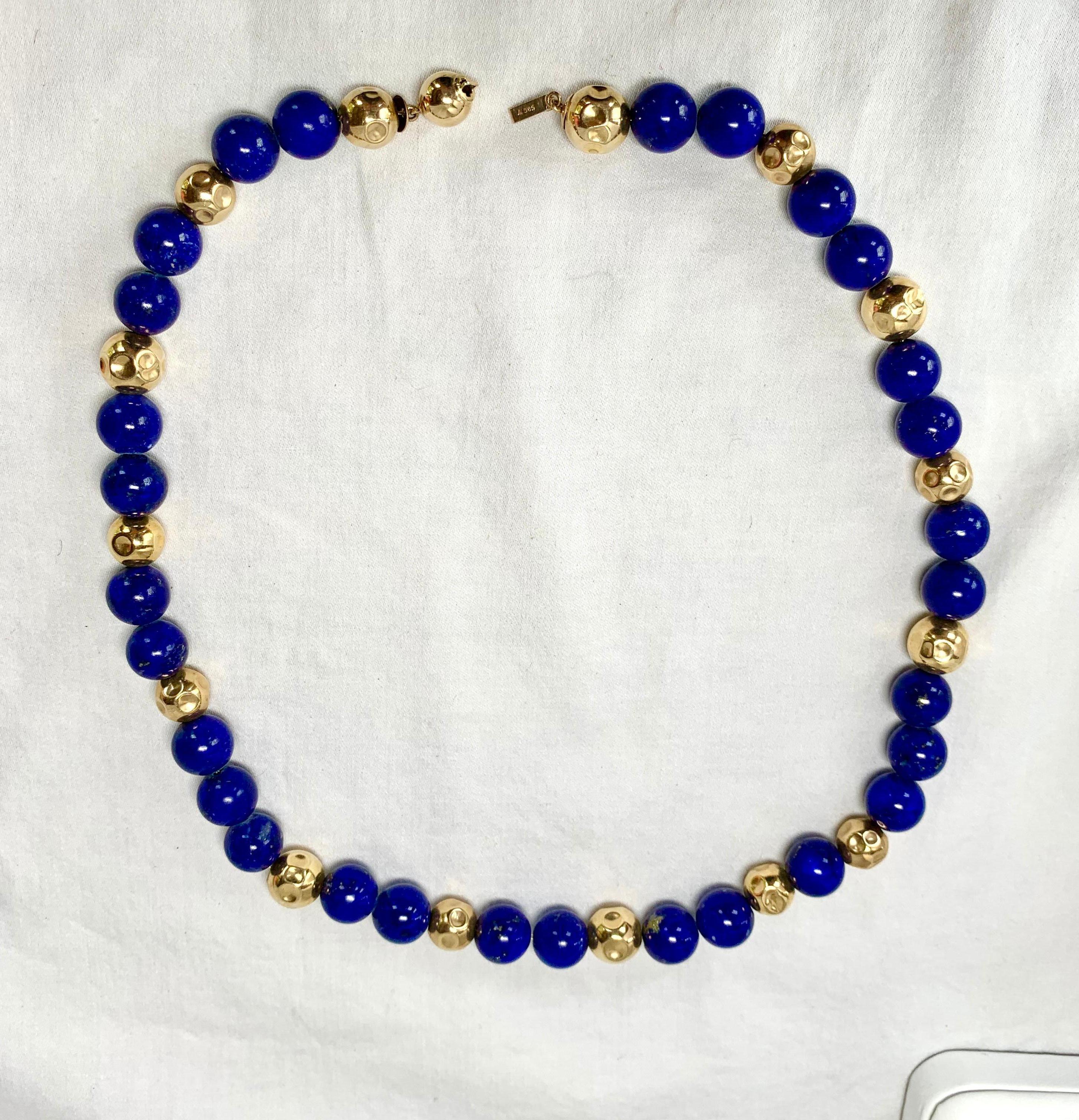 A STUNNING 17 INCH LONG LAPIS LAZULI AND 14 KARAT GOLD BEAD ESTATE NECKLACE.  THE VIVID BLUE LAPIS LAZULI BEADS ARE BEAUTIFULLY FLECKED WITH GOLD AND ARE 10MM IN DIAMETER.  THE LAPIS BEADS ARE SET WITH GORGEOUS 14 KARAT GOLD BEADS WITH DECORATIVE