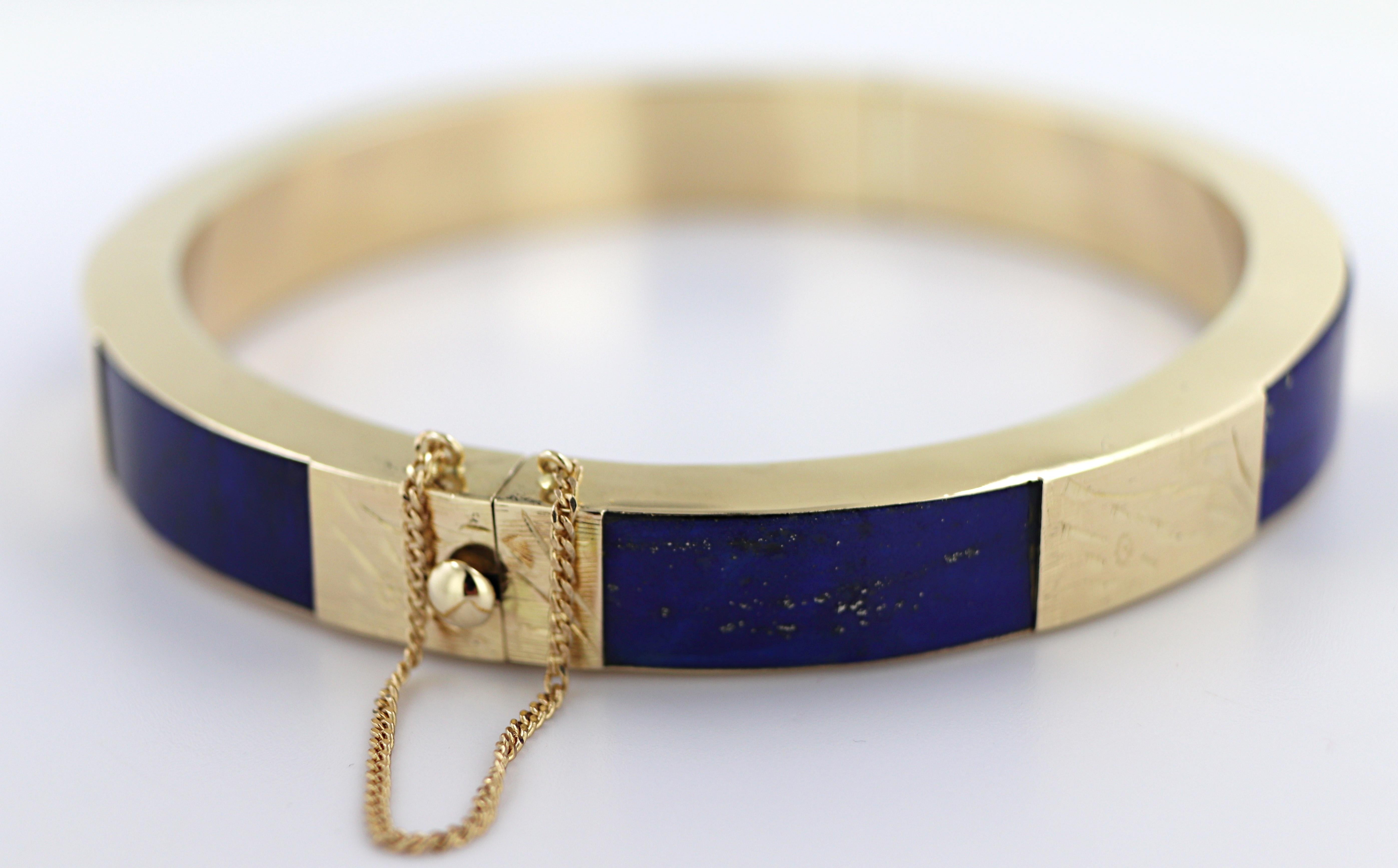 Featuring (6) inlaid segments of Lapis lazuli, 19.1. X 6.8 mm, interspaced and set in a foliate engraved
14k yellow gold hinged bangle mounting, 8.7 X 4.8 mm, 56.7 mm widest internal diameter, completed
with a pressure locking clasp and safety