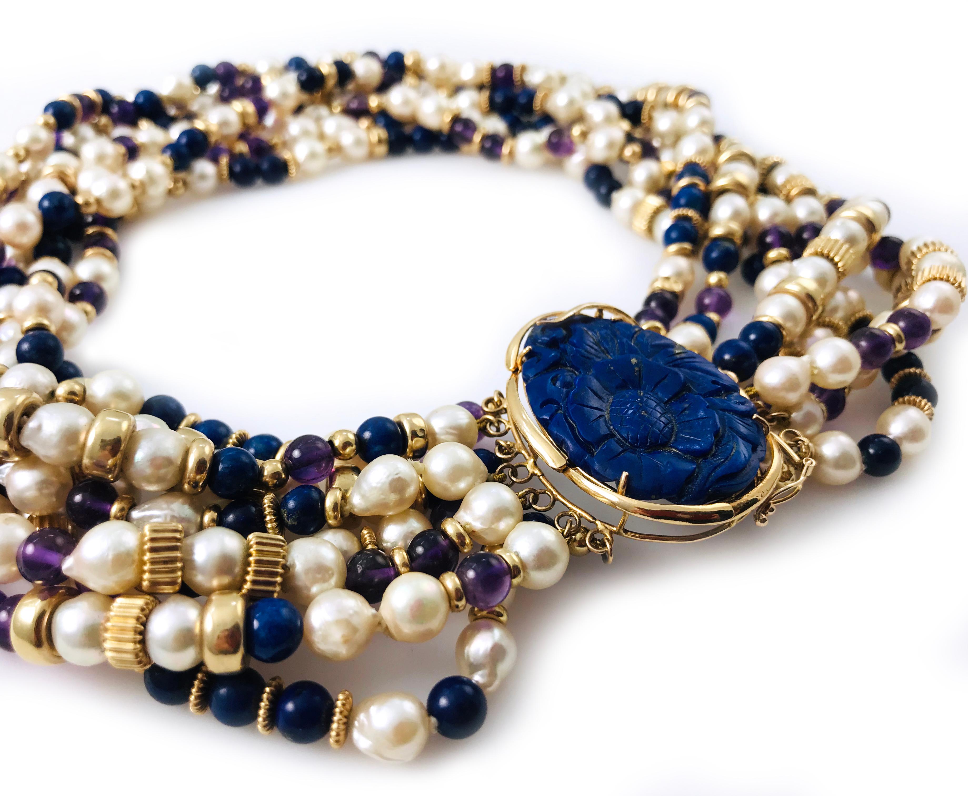 Lapis Lazuli Amethyst Pearl Choker Necklace. The center oval Lapis Lazuli has a craved flower motif. The necklace features eight strands of Baroque pearls, gold roundel beads, amethyst and lapis lazuli. The necklace is 17 inches long.