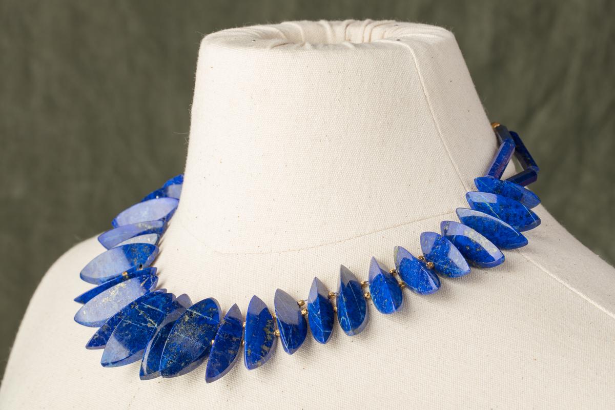 Unusually cut wedge-shaped lapis beads with 22K gold spacers.  Natural lapis and excellent color with flecks of pyrite (as all natural lapis should have).  22K gold S-hook with a bit of extra chain at the back to allow the length to fall between 16