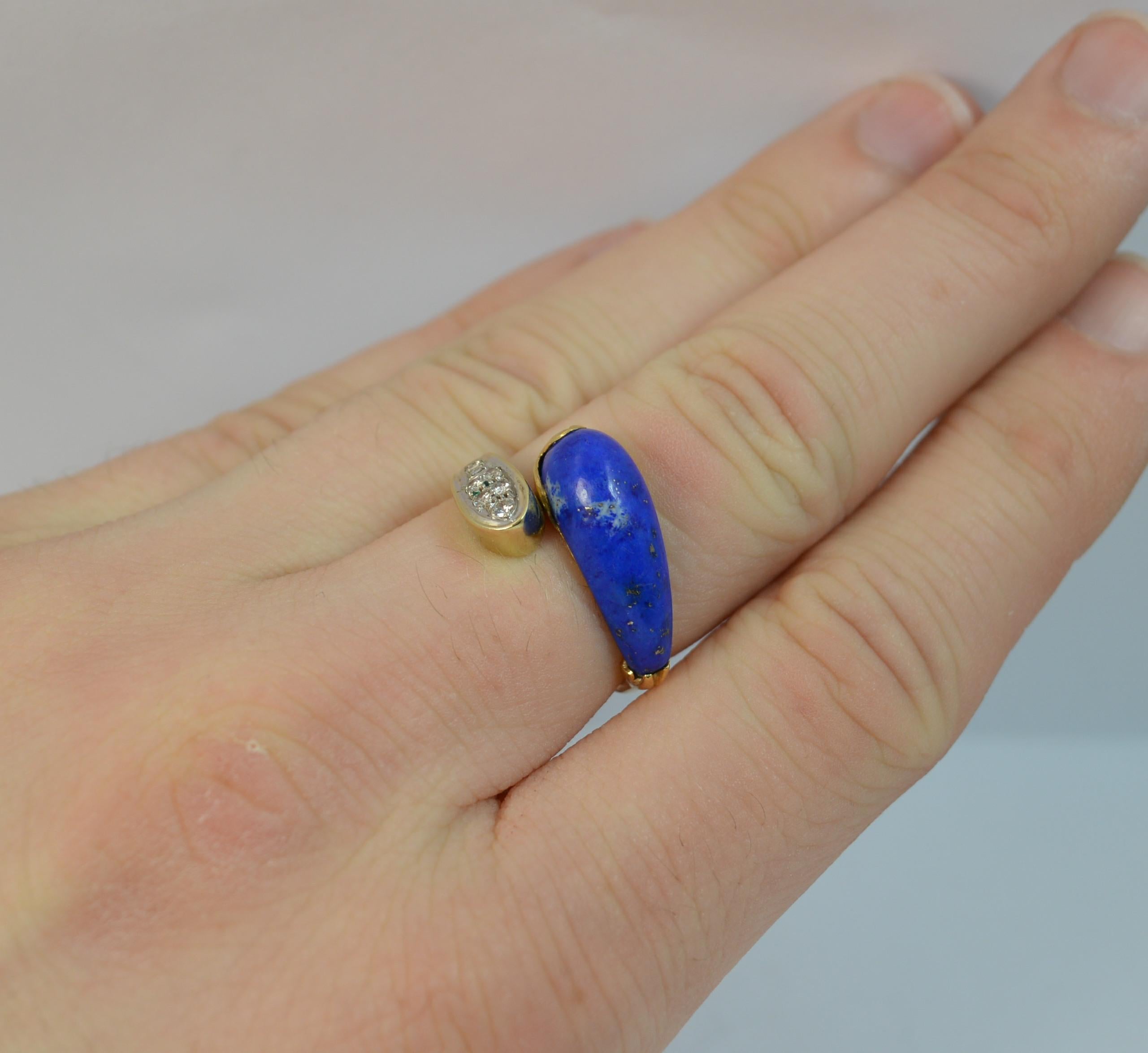 
A stylish ladies ring. Modelled in 14 carat yellow gold throughout.

Designed with a single lapis lazuli stone to one side and seven natural diamonds to the other on a twist.

12.5mm wide piece to the front.

CONDITION ; Very good. Clean and strong