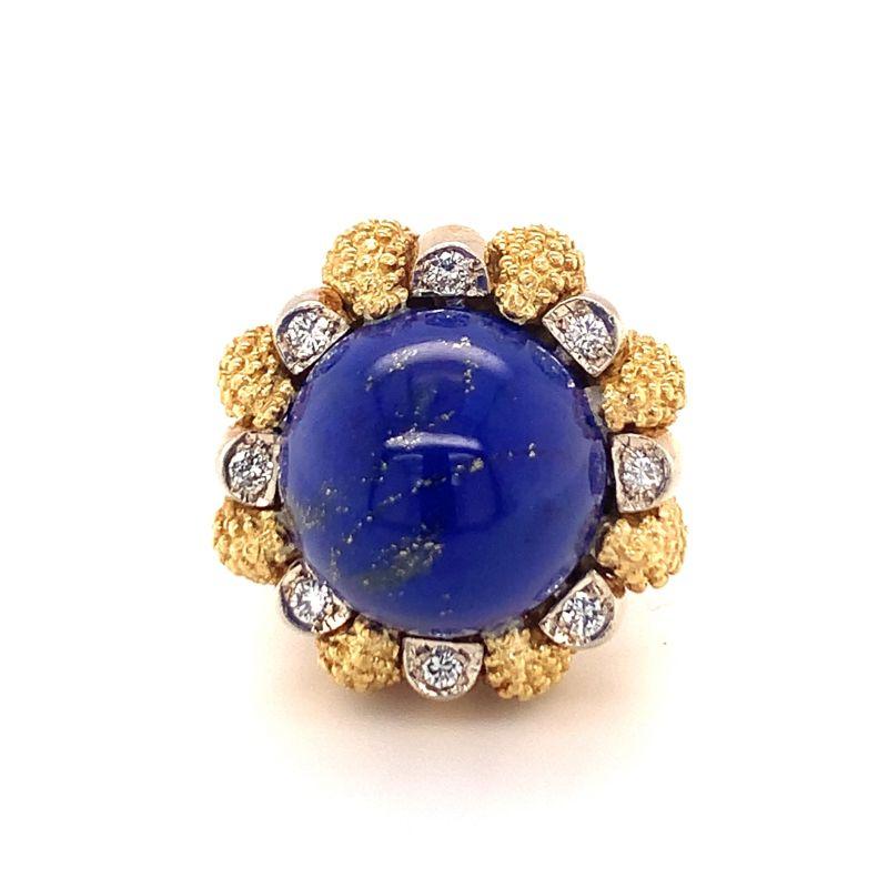One lapiz lazuli and diamond 18K yellow gold cocktail ring centering one round royal blue lapiz lazuli stone surrounded by gold beaded work and 8 round brilliant cut diamonds weighing approximately 0.50 ct. in total. Top-notch, domey,