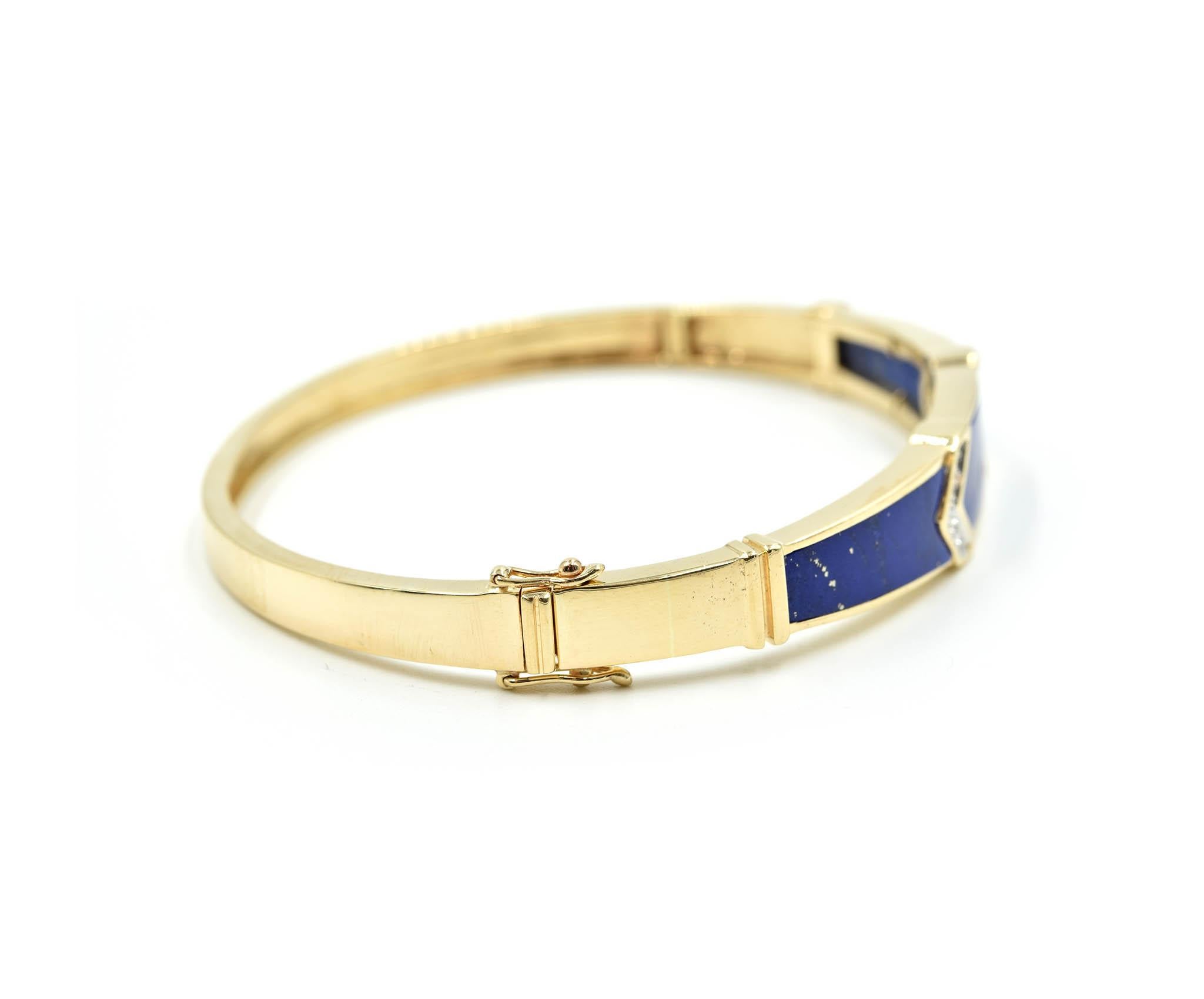 Designer: custom design
Material: lapis lazuli and 14k yellow gold
Diamonds: 10 round cuts = 0.05 carat total weight
Dimensions: bangle will fit up to a 6 ½ inch wrist and is ½ an inch wide
Weight: 18.47 grams
