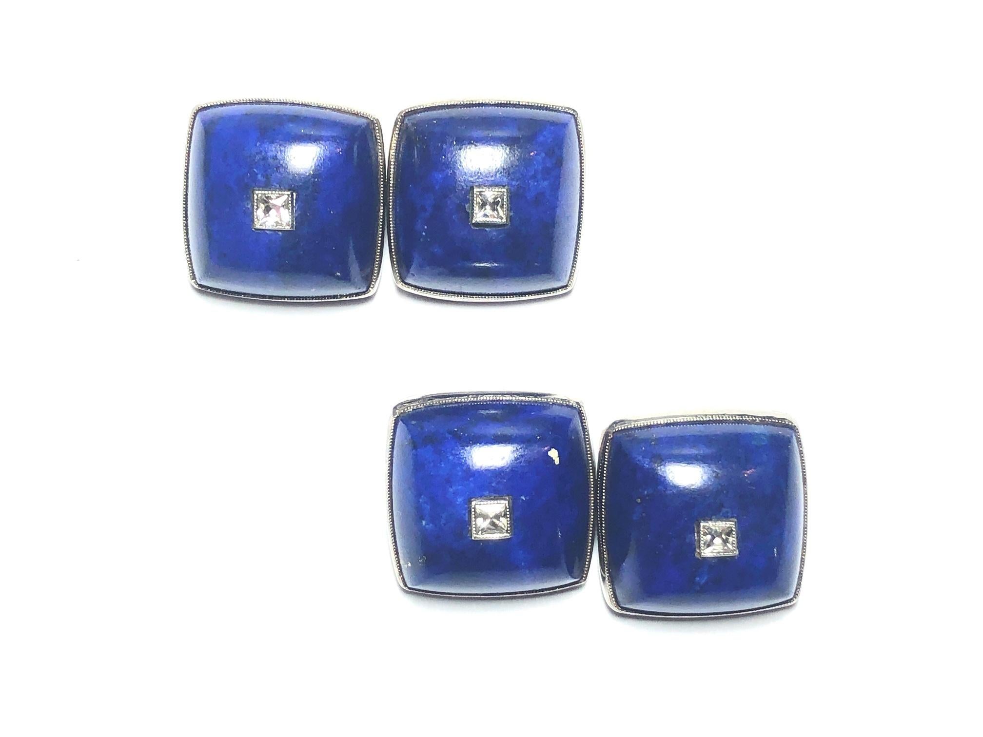A pair of vintage lapis lazuli and diamond cufflinks, with French-cut diamonds, in the centre of cushion shaped lapis lazuli, in rub-over settings, with millegrain edges, mounted in 18ct white gold, with bar links, circa 1950.