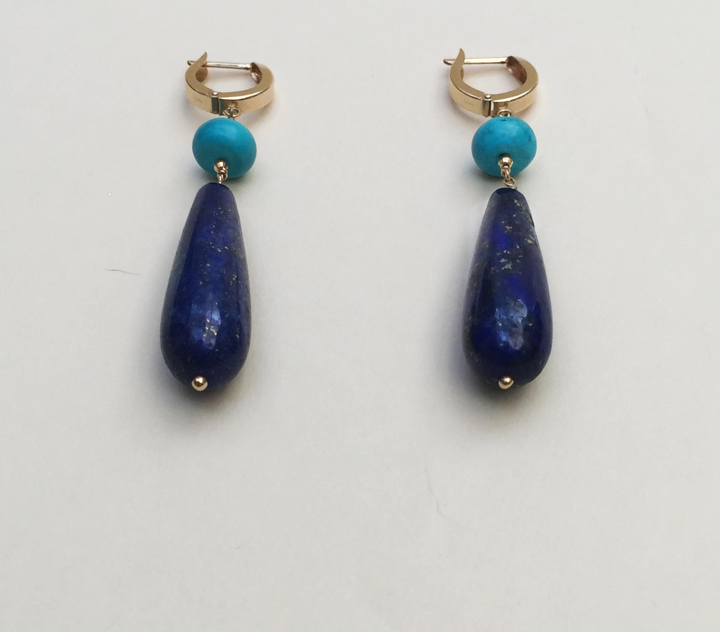 This lapis lazuli and turquoise earrings are highlighted with 14k yellow gold faceted beads and lever backs. Shimmering within the lapis lazuli are veins of gold, adding a natural shine to the earrings. Accenting the deep blue of the lapis lazuli
