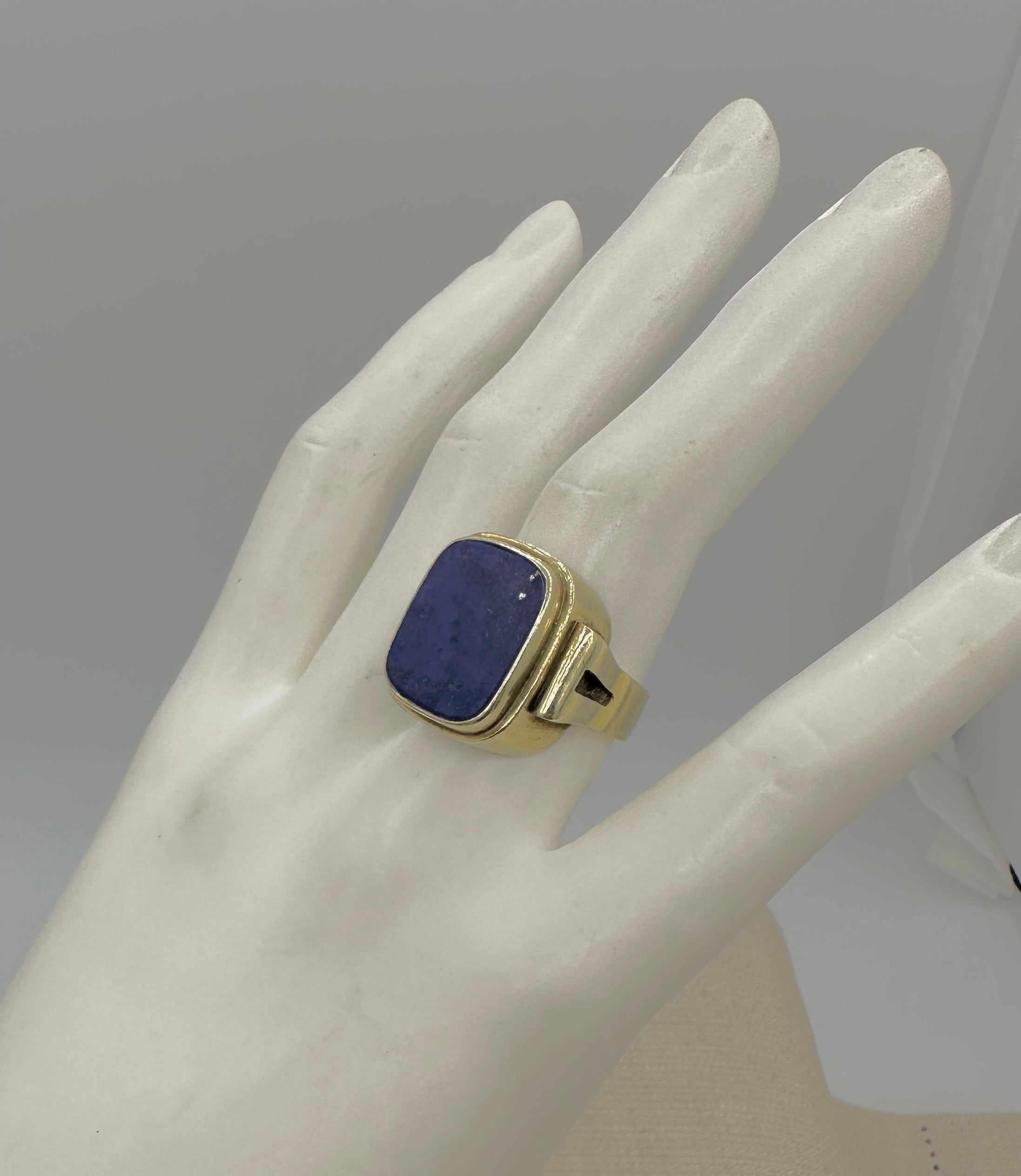 Indulge in a stunning antique Art Deco Lapis Lazuli Ring in 14 Karat Yellow Gold.  The fabulous ring has a wonderful rectangular lapis lazuli center with a gorgeous Art Deco design.  The lapis has gorgeous blue color and is flecked with beautiful