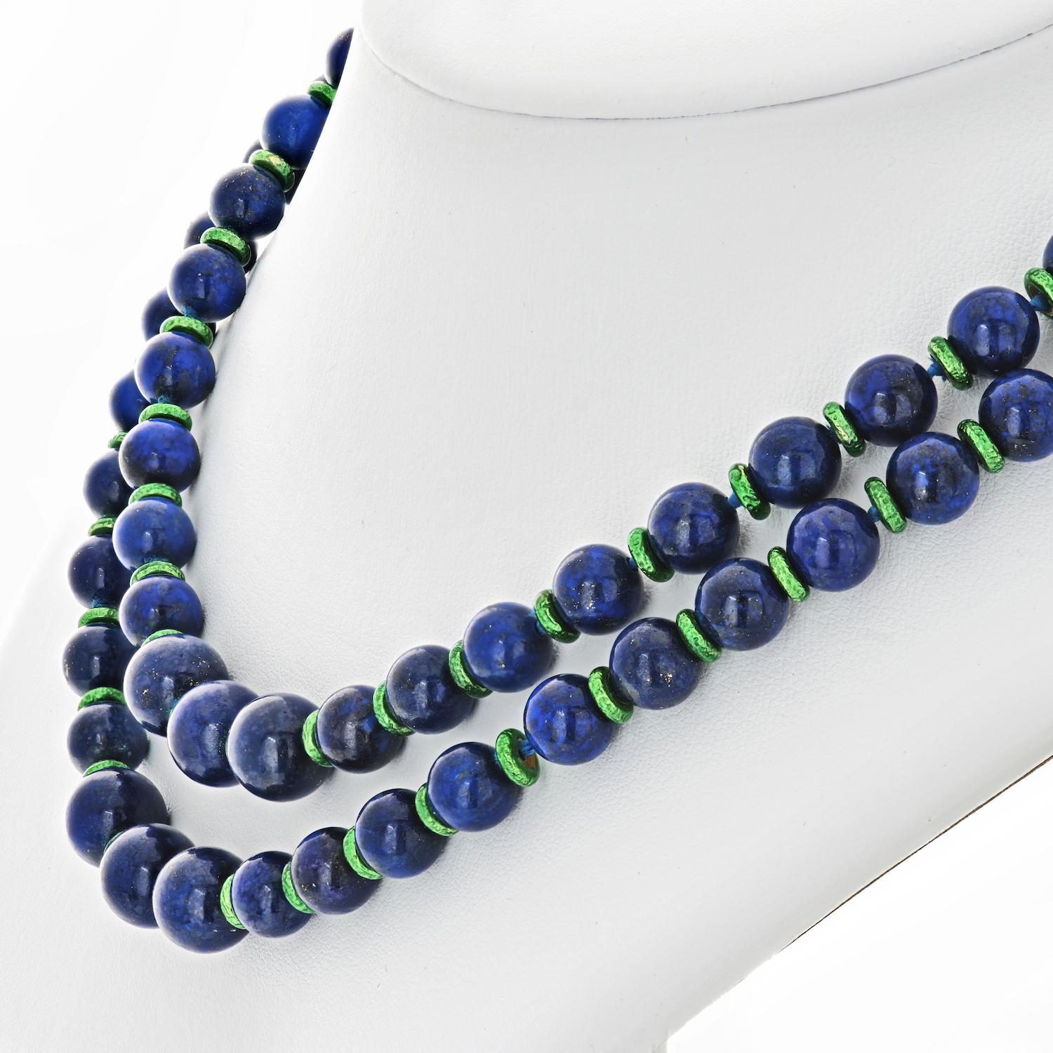 The lovely necklace is composed of lapis lazuli beads, forming a single long strand, completed with a 18k gold clasp and accented with a touch of green enamel in between stations. 

And one more thing: this necklace can be worn as two separate bead