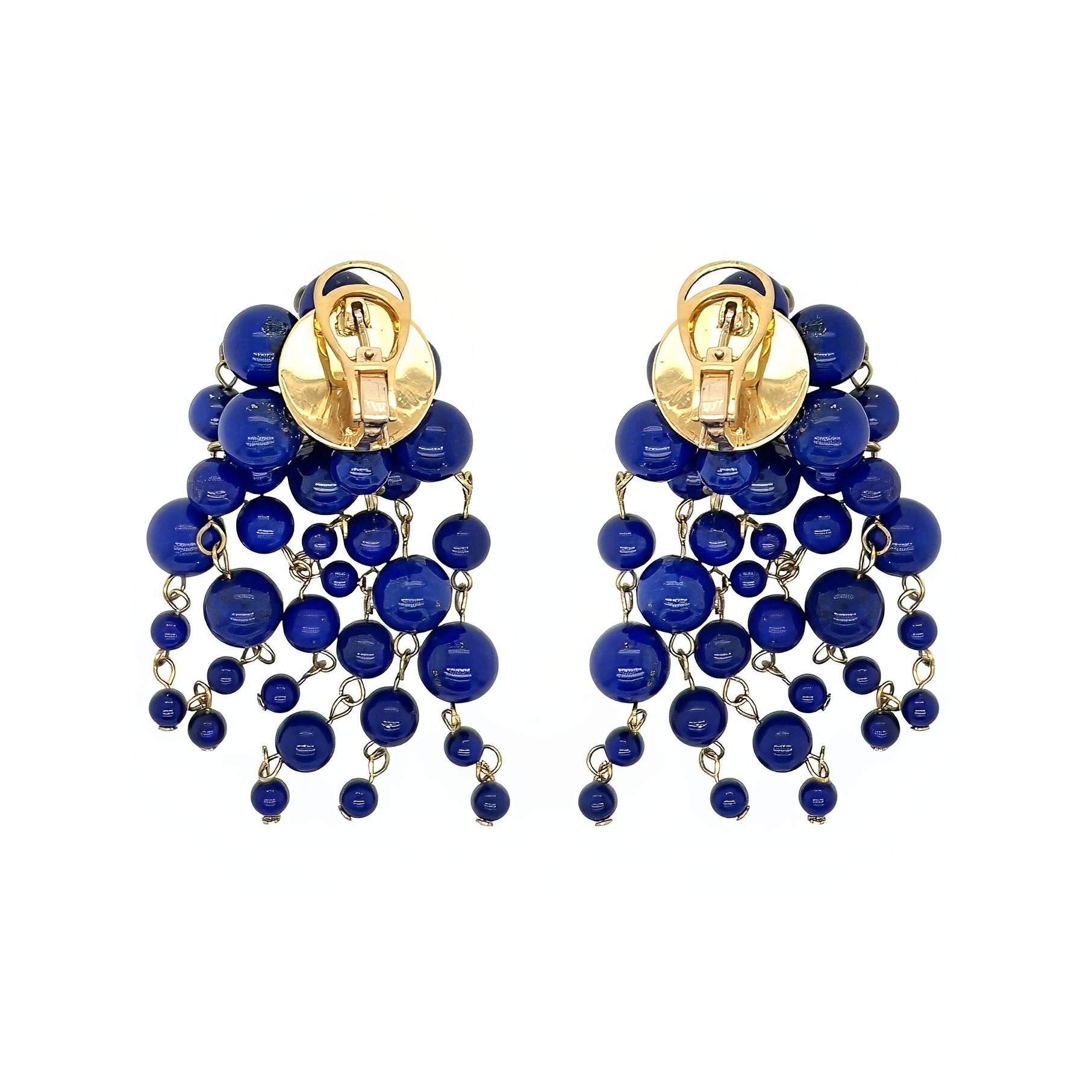A pair of 18 karat yellow gold and lapis lazuli bead waterfall earrings on posts with omega backs.  Each earring dangles seven lengths of five 4-8 mm lapis lazuli beads connected by yellow gold loops from a yellow gold disc.  Overall length 2 5/8
