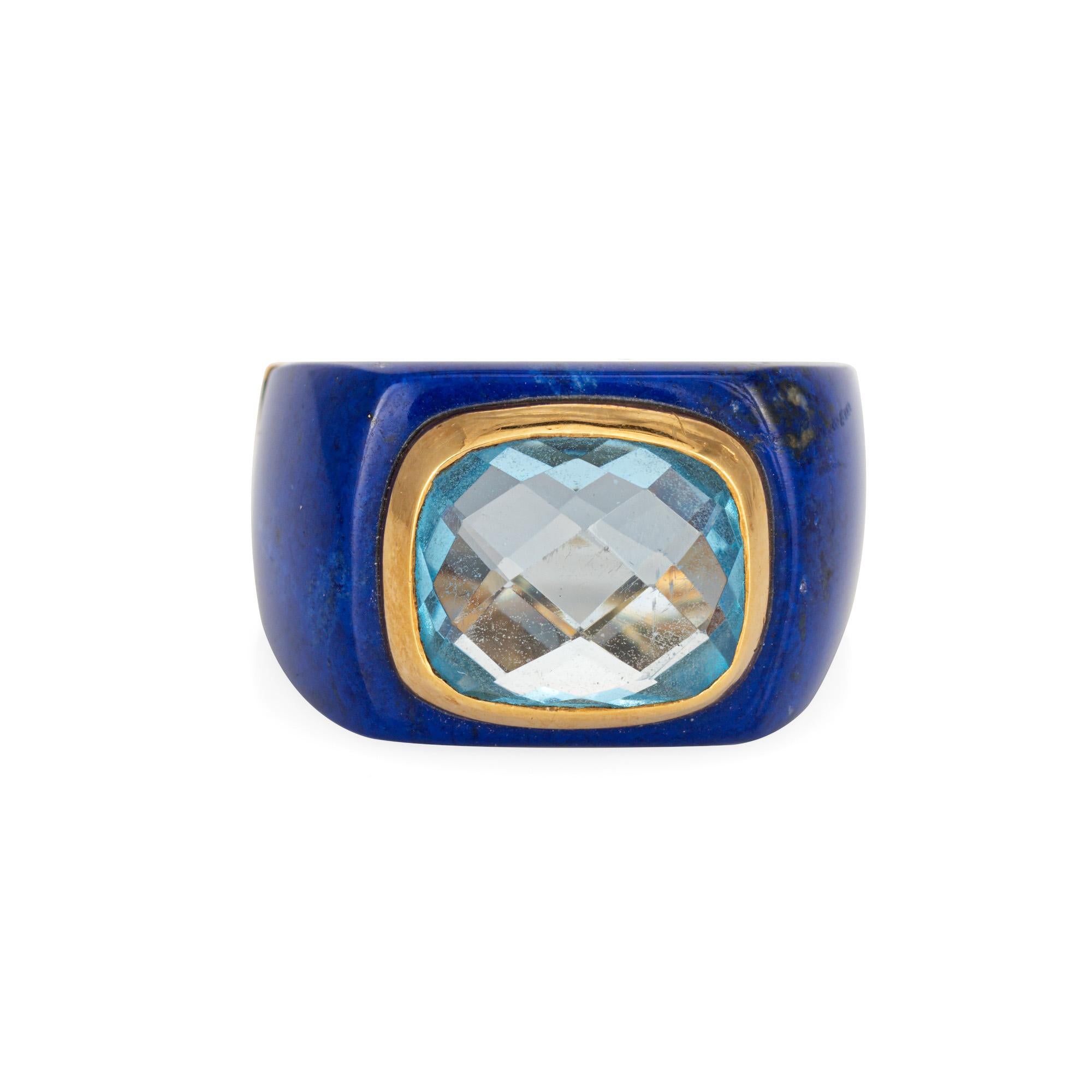 Stylish contemporary estate lapis lazuli & blue topaz cocktail ring crafted in 18 karat yellow gold. 

Checkerboard faceted blue topaz measures 11mm x 9mm. Lapis measures 14mm x 21mm. The topaz and lapis are in very good condition and free of cracks