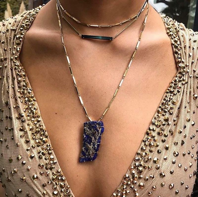 18 Karat Raw Lapis Lazuli necklace features a brilliant blue, custom cut natural Lapis Lazuli suspended on a 16 inch 18k Yellow Gold Bar chain. 
Includes lobster clasp closure at back of the neck
18k Yellow Gold, Natural Lapis Lazuli 
