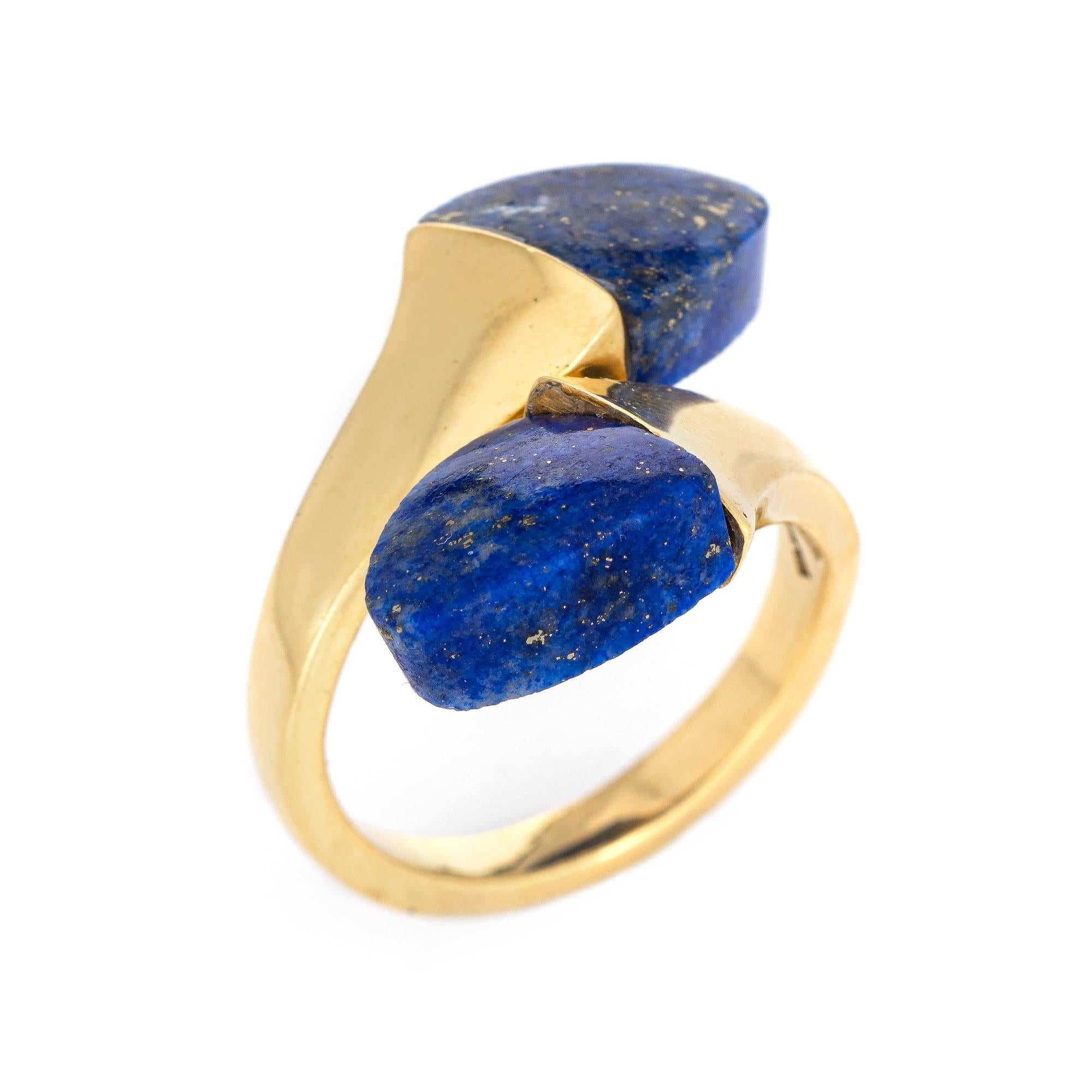 Stylish vintage lapis lazuli bypass ring (circa 1970s to 1980s) crafted in 18 karat yellow gold. 

Two pieces of lapis lazuli measure 10mm x 9.5mm. The lapis is in excellent condition and free of cracks or chips. 

The lapis lazuli is set in a