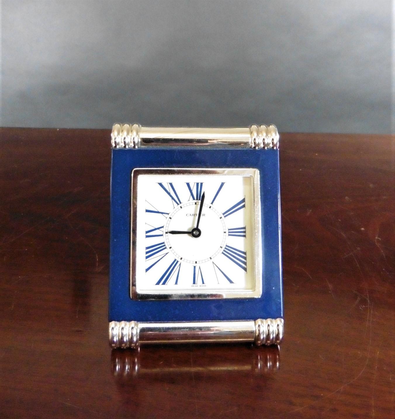 C A R T I E R

Lapis Lazuli Cartier travel clock


Rectangular strut frame with turned and ribbed chrome supports, Lapis Lazuli surrounding the chrome bezel outlining a painted dial with blue Roman numerals, original hands and alarm hand signed