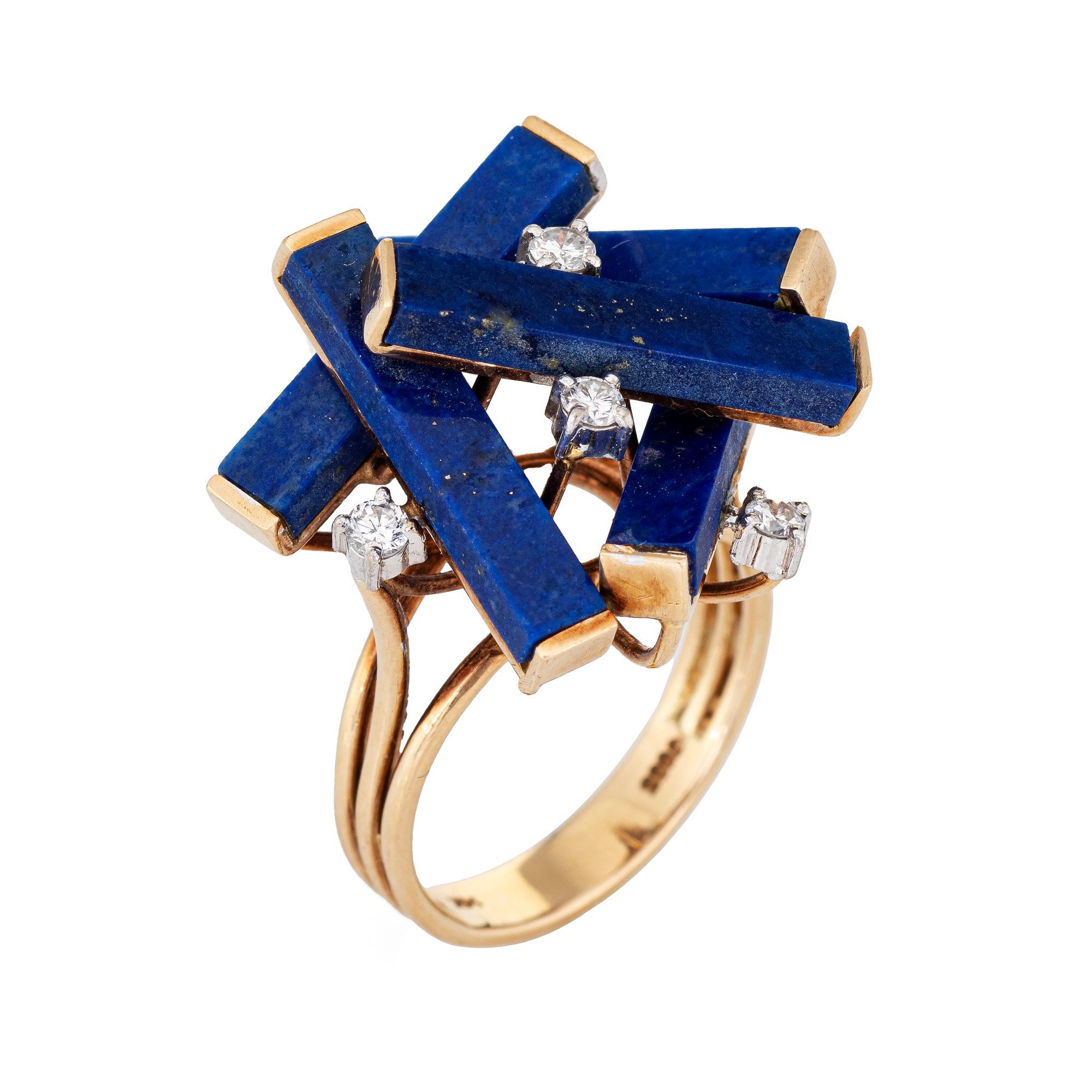 Stylish vintage lapis lazuli & diamond ring (circa 1960s to 1970s) crafted in 14 karat yellow gold. 

Five pieces of lapis lazuli measures 17mm x 3mm, accented with an estimated 0.15 carats of diamonds (estimated at G-H color and VS2-SI1 clarity).