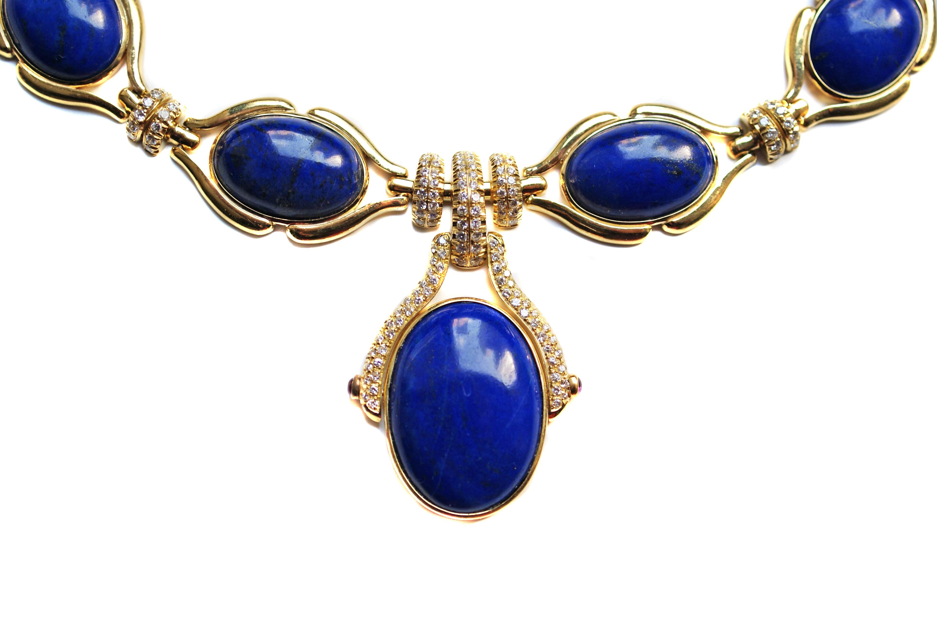 Finely crafted 18 karat yellow gold necklace set with 12 deep azul blue lapis lazuli cabochons. Each of these cabochons have been picked to match perfectly in color and have an approximate total weight of 185 carats. Embellishing this necklace, 234