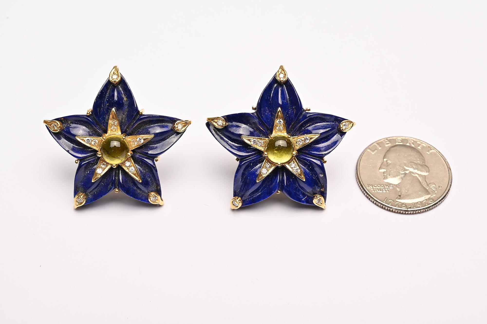 Bold and unusual  earrings with the star made of carved lapis lazuli; a cabochon peridot in the center surrounded by a diamond star and tips. The backs are posts. Arms of the lapis star measure 1 1/2 inches in diameter.