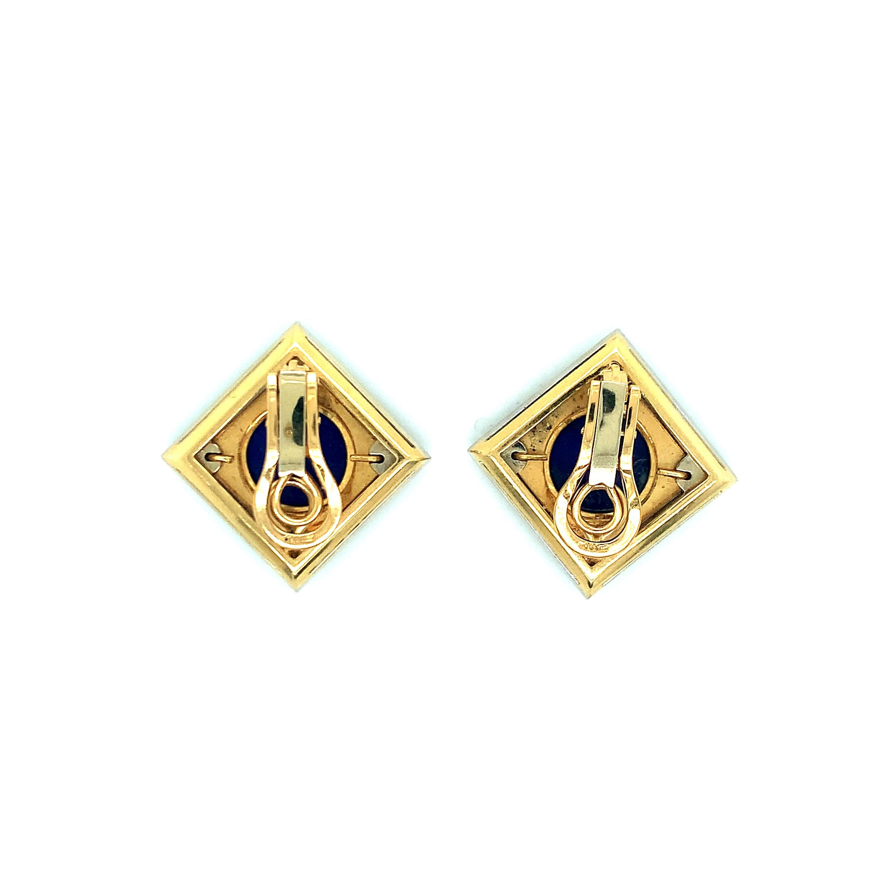 A pair of lapis lazuli and diamond ear clips, featuring 18 karat yellow and white gold. At their center appears a circular lapis lazuli inlay accented with a border of sixty-four round full-cut diamonds totaling approximately 4 carats and graded G-H