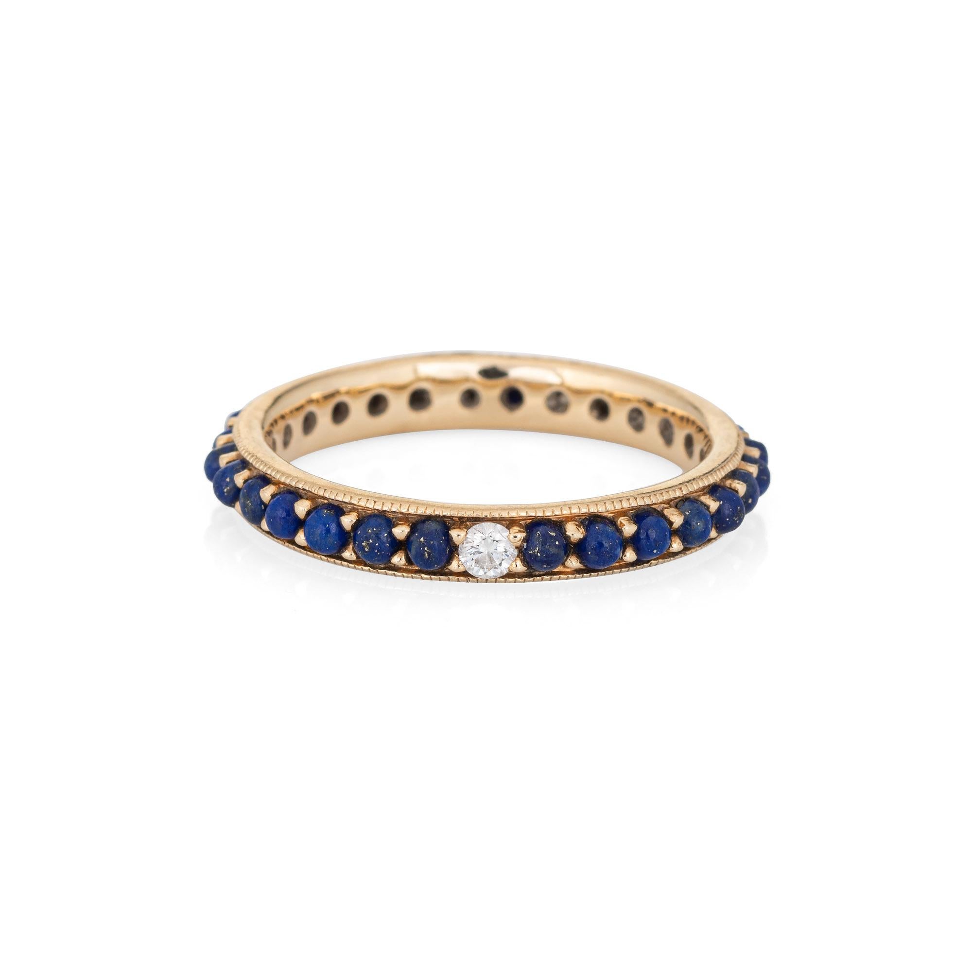 Stylish lapis lazuli & diamond eternity ring crafted in 14 karat yellow gold. 

Cabochon cut lapis lazuli measures 1.5mm each. The diamond is estimated at 0.02 carats (estimated at H-I color and SI1 clarity). The lapis is in very good condition and
