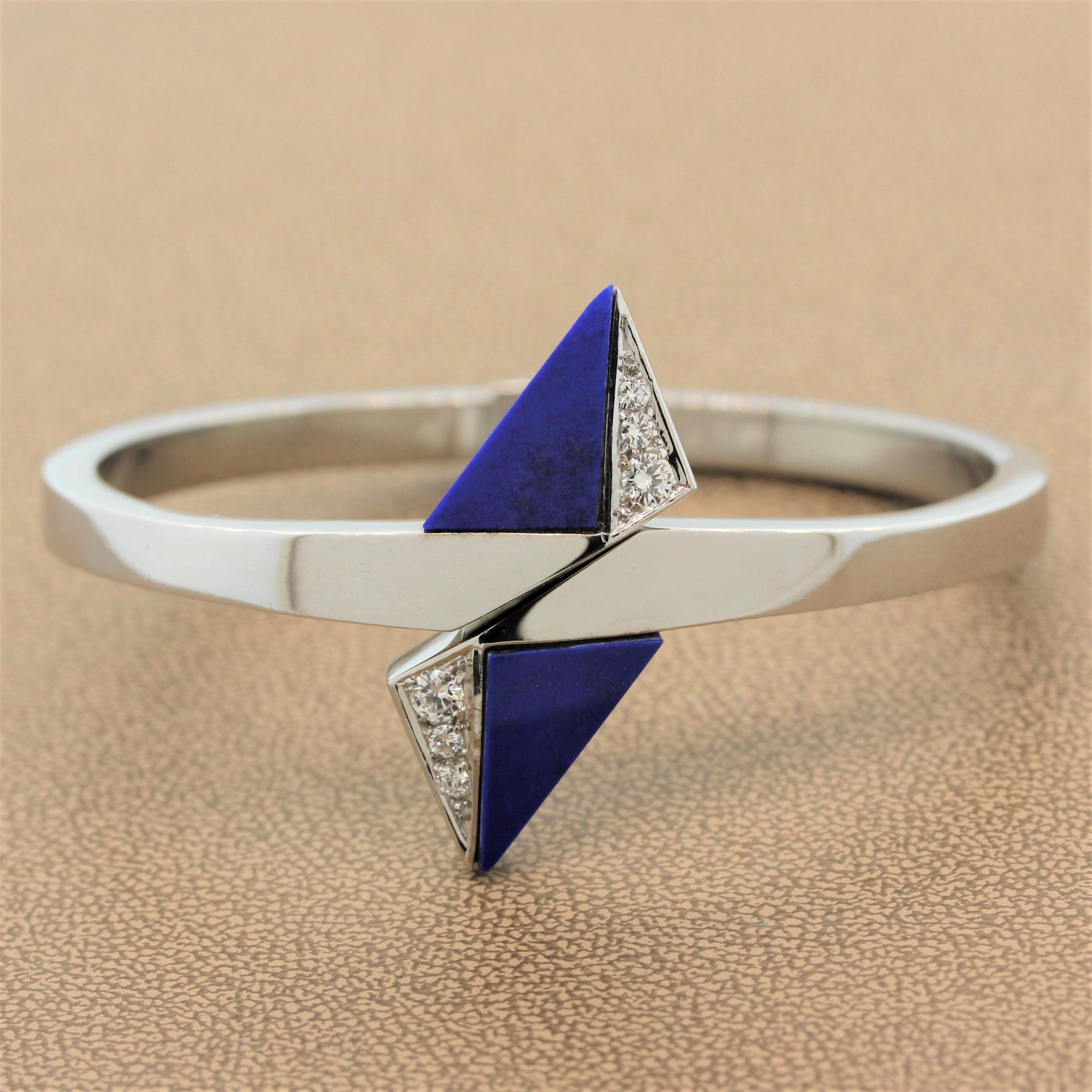 A perfectly geometrical cuff featuring trillion cut lapis lazuli beside approximately 0.25 carats of round cut diamonds in a triangular 18K white gold setting. The solid cuff opens with a simple stretch of the two sides.

Cuff Size: 6.50 inches
