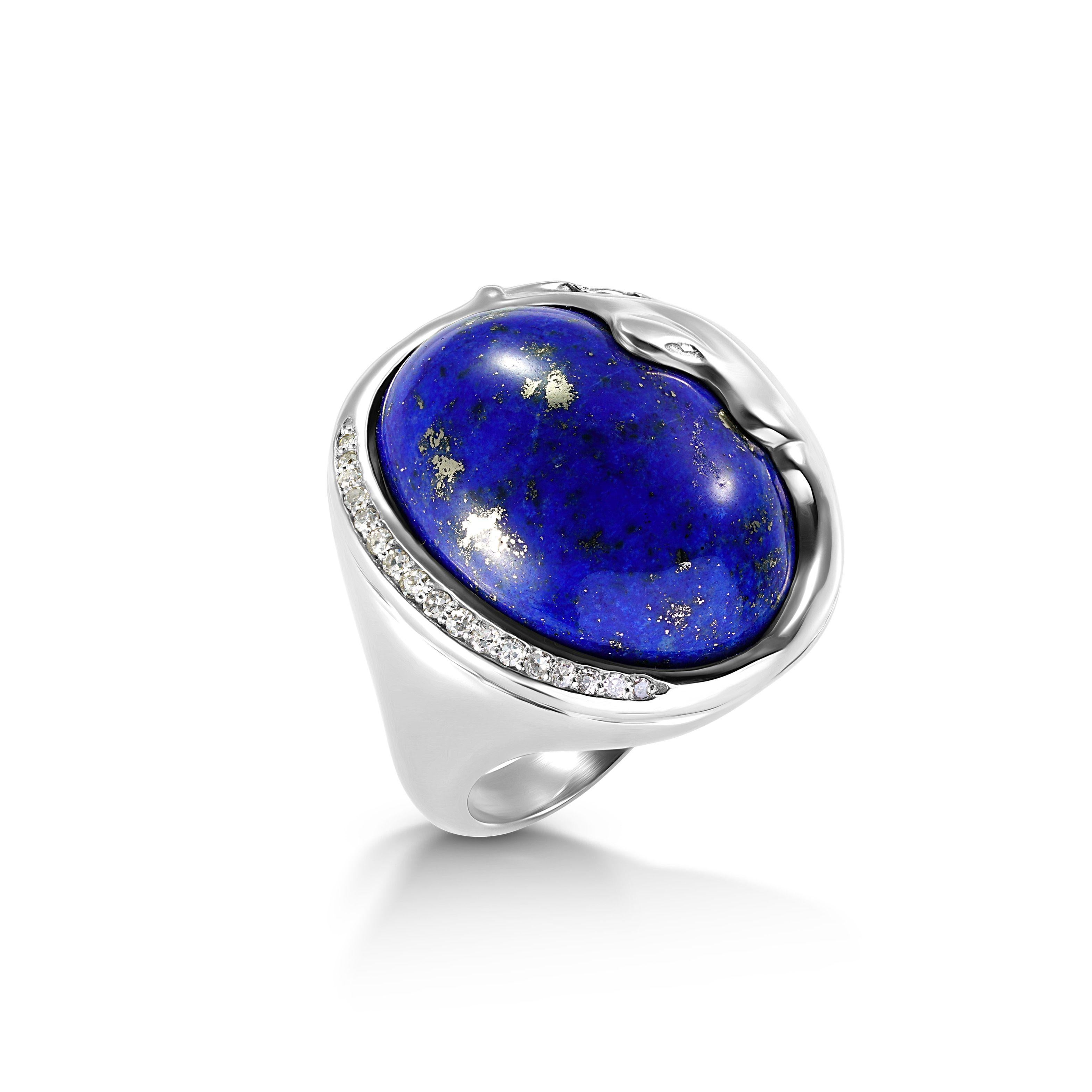 Simply Beautiful!  Lapis Lazuli and Diamond Cocktail Ring, securely centered by a 24 Carat Oval Lapis Lazuli Gemstone, one side accented by Diamonds, approx. 0.10tcw. Hand crafted 18K White Gold mounting. Ring size 8.5, we offer ring resizing. More