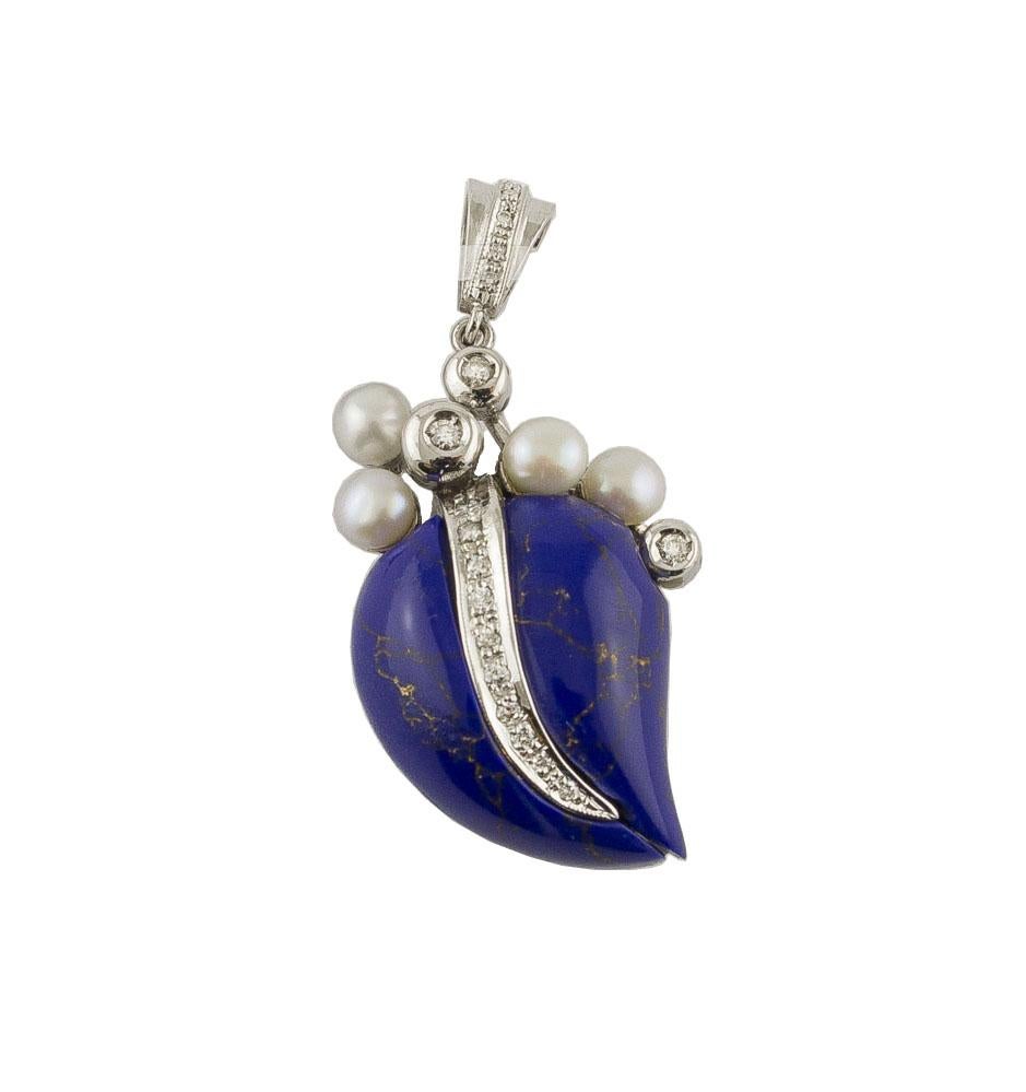 

Charming pendant necklace in 14Kt white gold composed by heart shaped lapis lazuli and surrounded by a group of little pearls and diamonds. 
Lapis Lazuli 2.80 g
Pearls 0.40g    4/5 mm  
Diamonds 0.20 ct
Total Weight 12.70 g
R.F + goai
Dimentions
