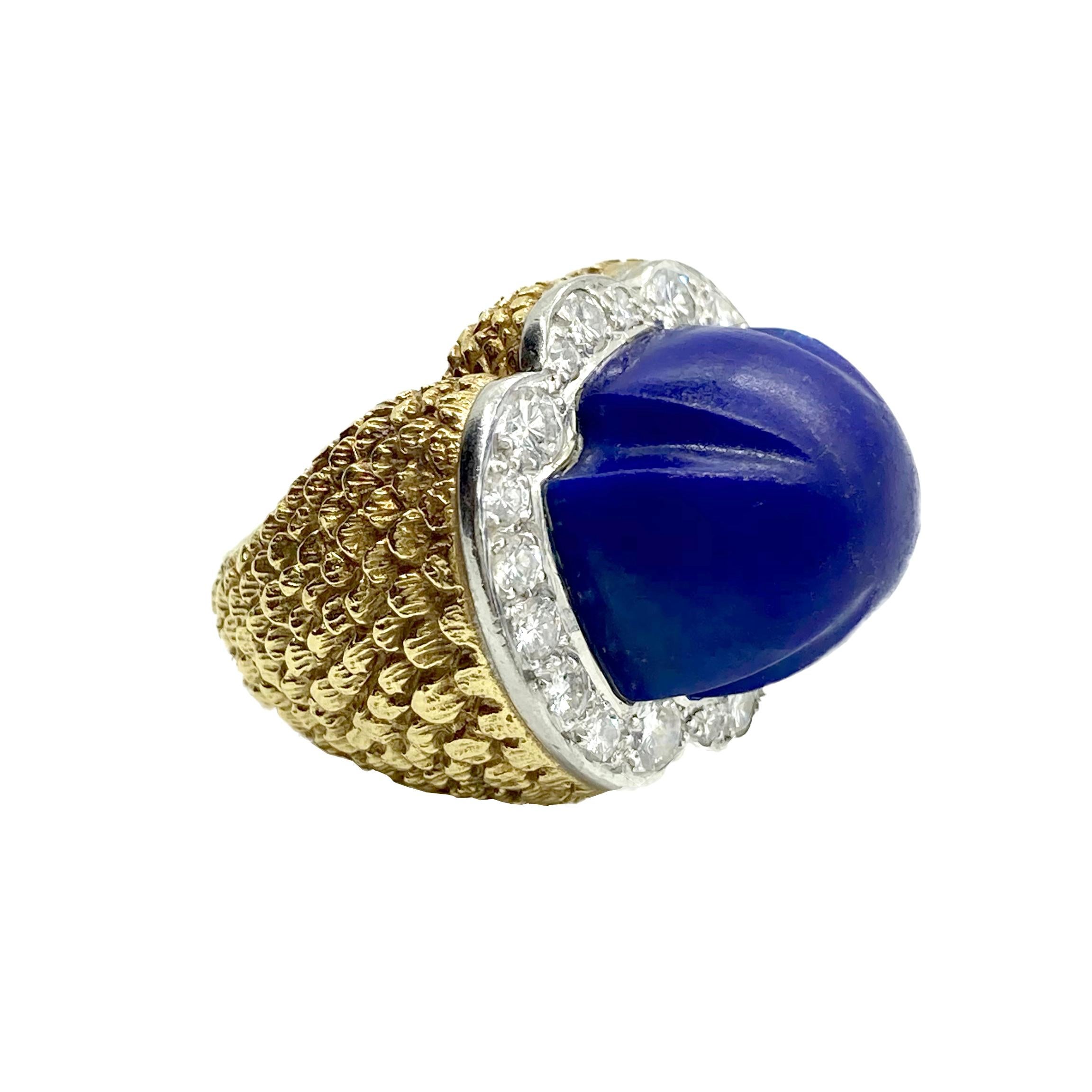 A chic 18 karat yellow gold and platinum ring centering a large lapis bead, embellished with 20 round cut diamonds totaling 1.50 carats. 