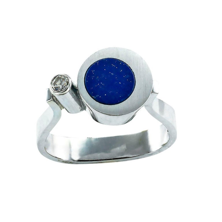 Lapis lazuli diamond and white gold Art Modern ring circa 1970. *

ABOUT THIS ITEM:  Do you want a fun artsy ring that is totally different?  You are looking at one.  The asymmetrical design is eye catching, and that little diamond lends a sparkling