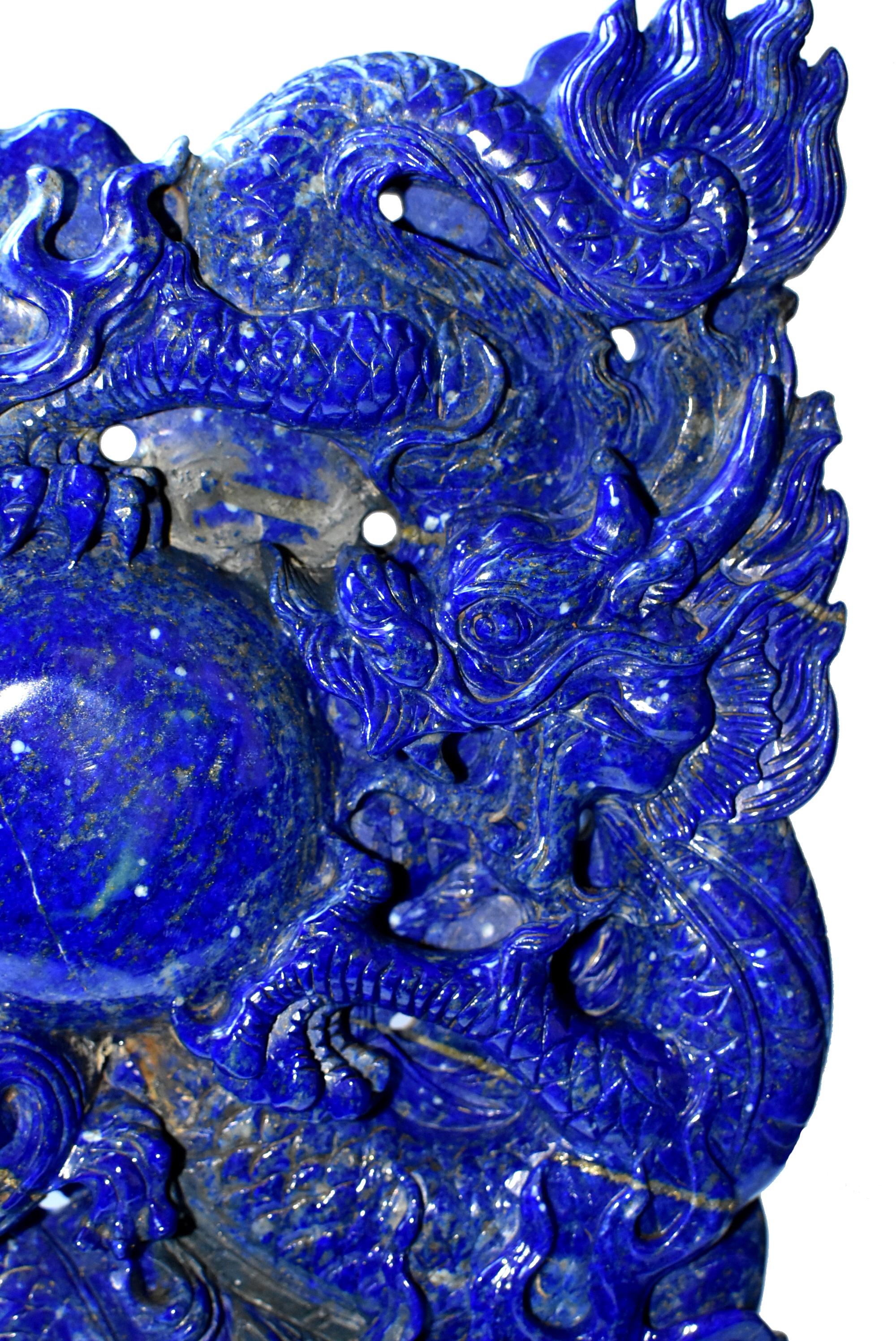 The absolute best grade of natural lapis anyone can find. This statue is carved from a solid boulder of natural, 1st grade lapis lazulli, with the brightest, bluest natural color and slight snows and gold accent. Reflecting 2 dragons circling around
