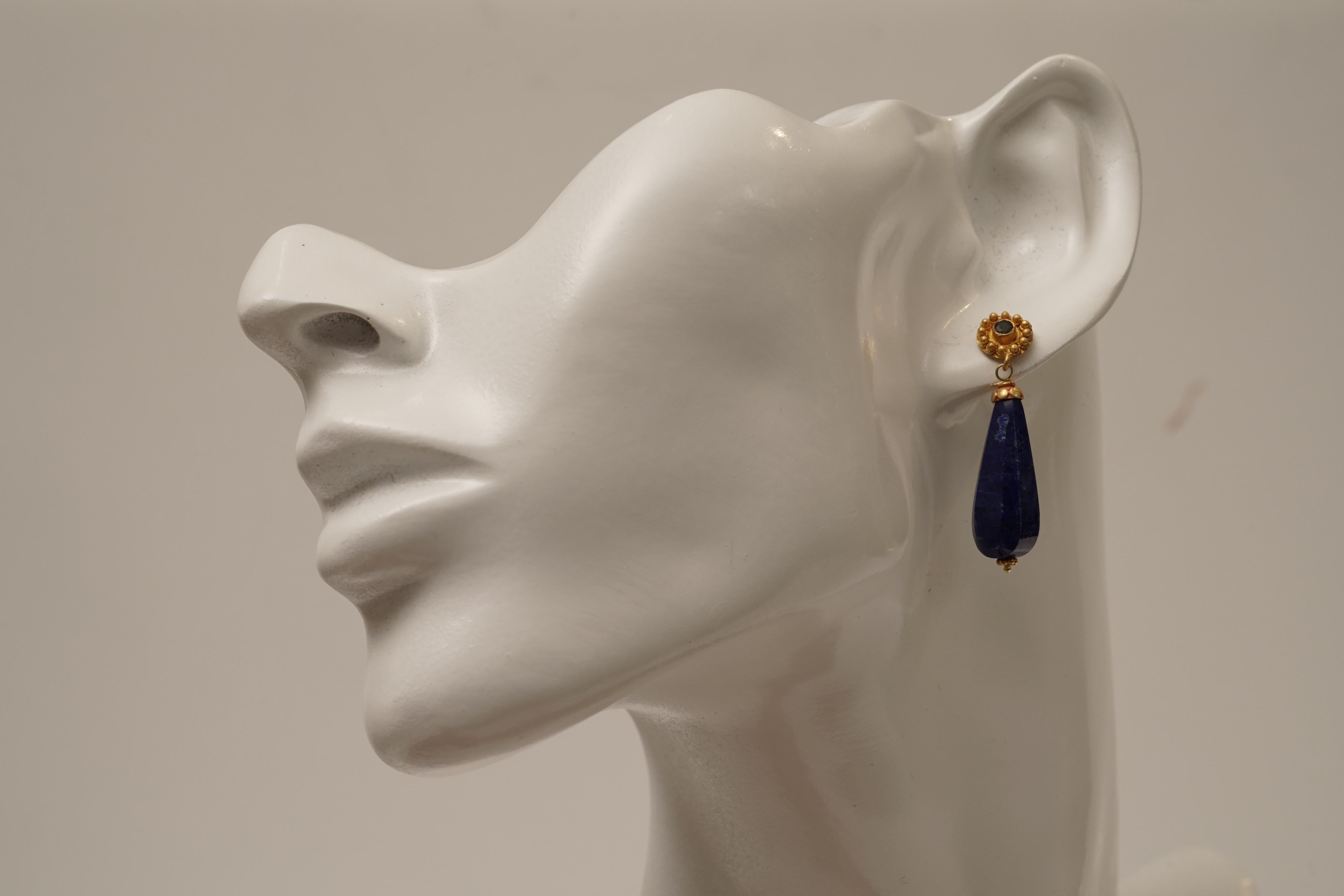 Pear-shaped and beveled natural lapis drop earrings with a 22K gold post and faceted emerald post for pierced ears.  By Deborah Lockhart Phillips