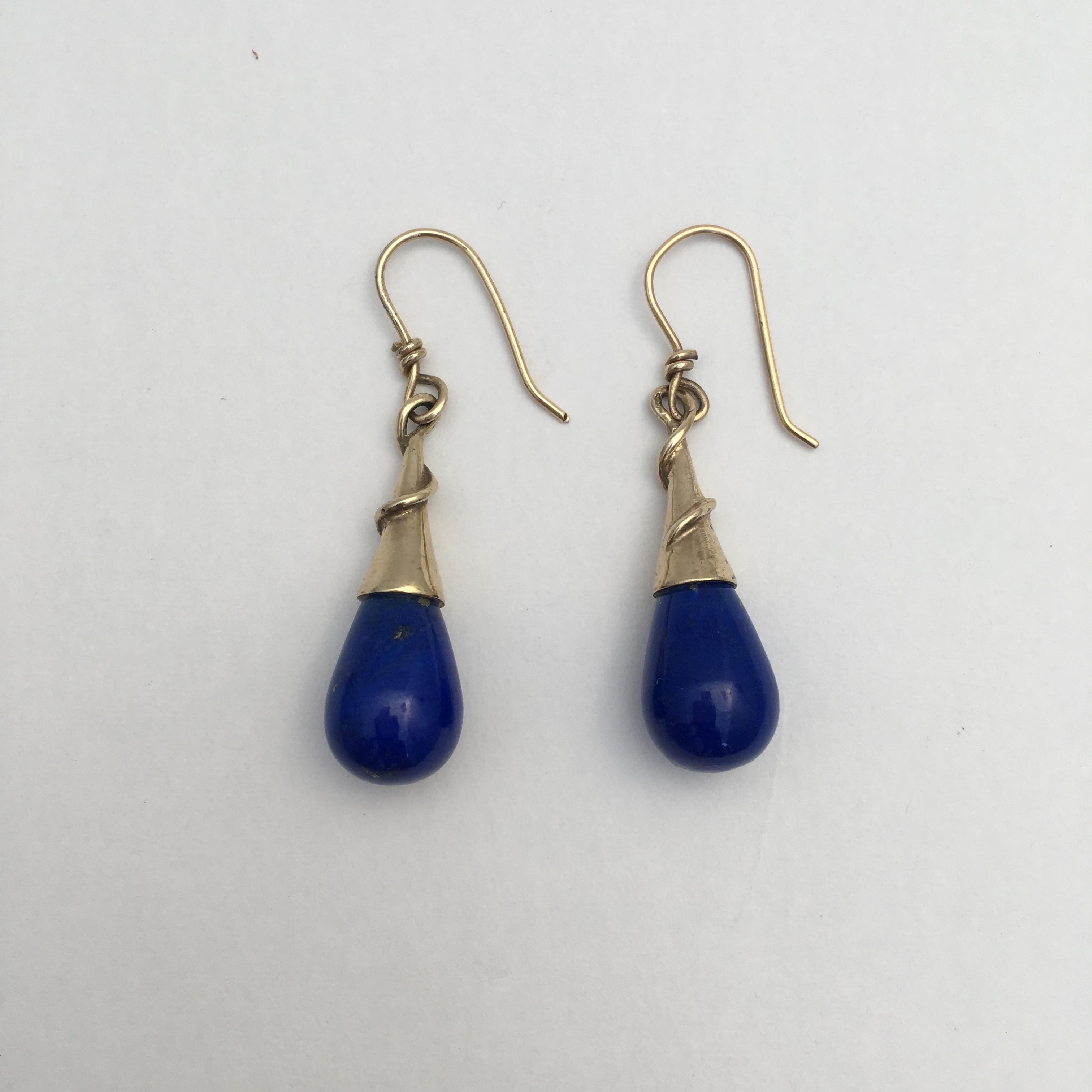 The rich cobalt blue of these stylish earrings catches the eye beautifully, the lapis lazuli and yellow gold working perfectly together. The clever design creates a spiral effect around the gold mounts, while the delicious lapis stones appear like