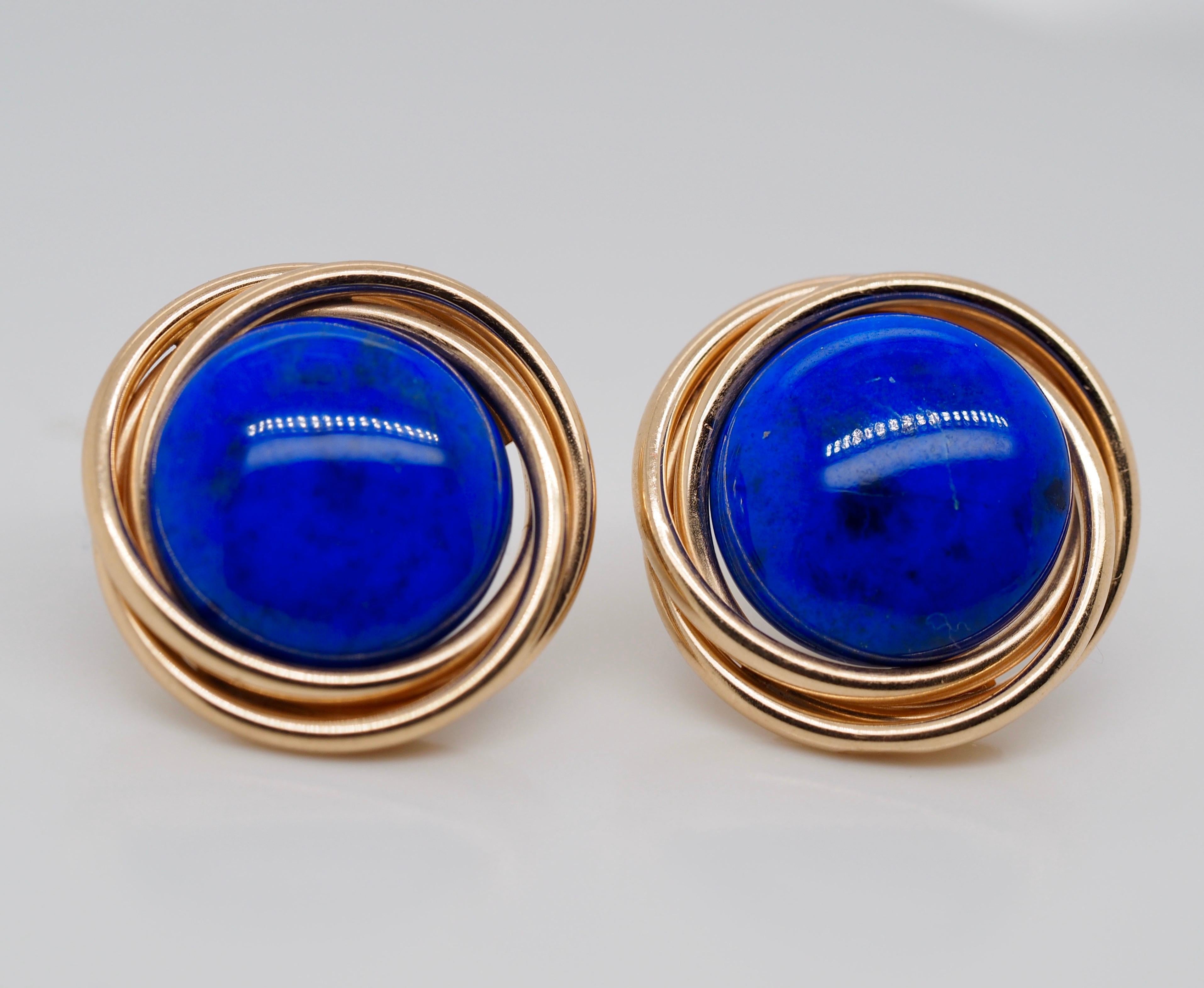 Cabochon Lapis Lazulli earrings with 14 karat yellow gold posts and base metal ear nuts measuring 15.15 x 3.90 mm enhanced by 14 karat yellow gold intertwined jackets.  21.37 mm in diameter with jackets. The center lapis are illuminating in a bright