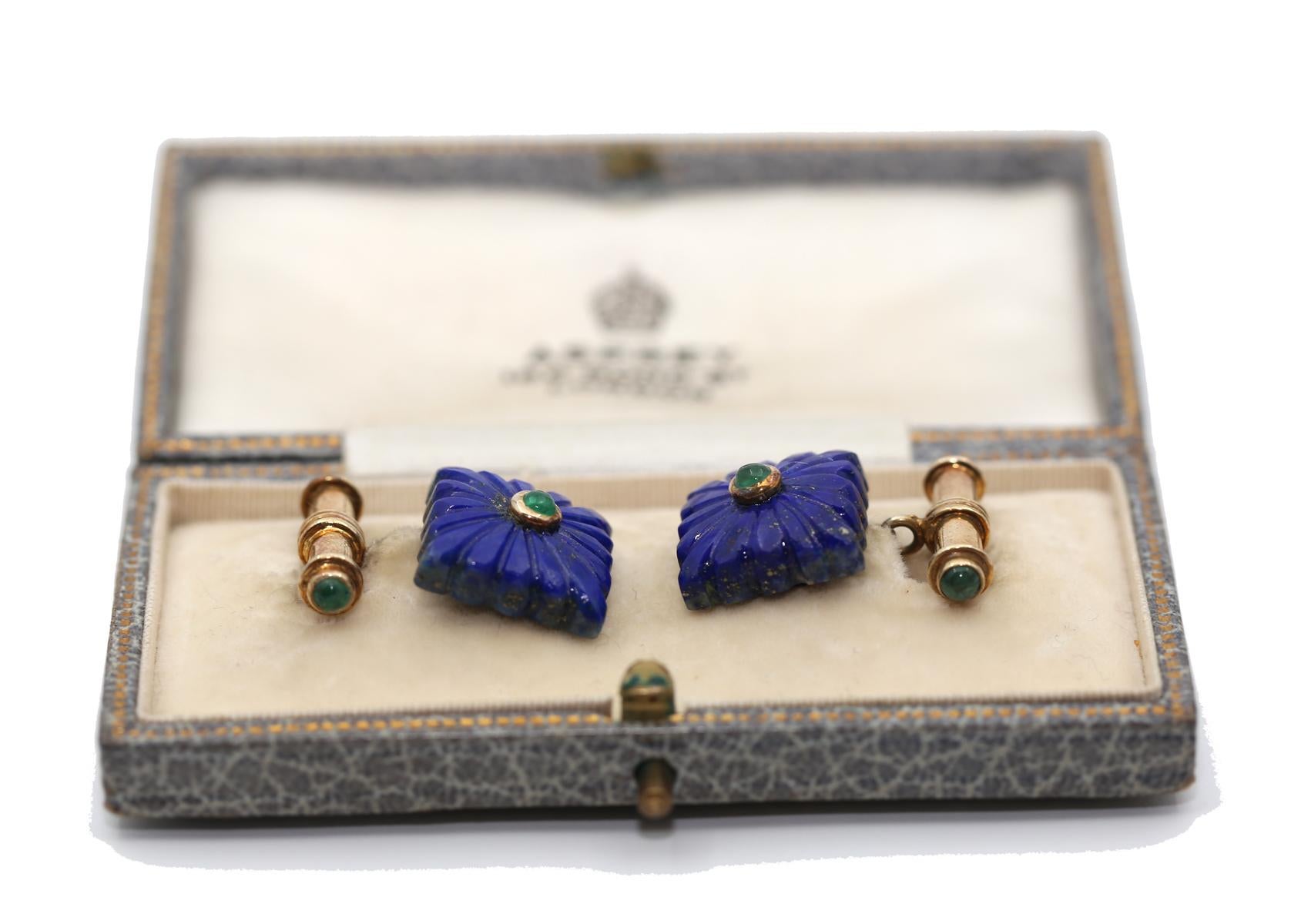 Lapis Lazuli Emerald Cufflinkscreat was created around 1930.

A Pair Of Vintage Lapis Lazuli And Emerald Cufflinks, each comprising a carved lapis lazuli set with a round cabochon Emerald, the baton terminating at each end with a further round