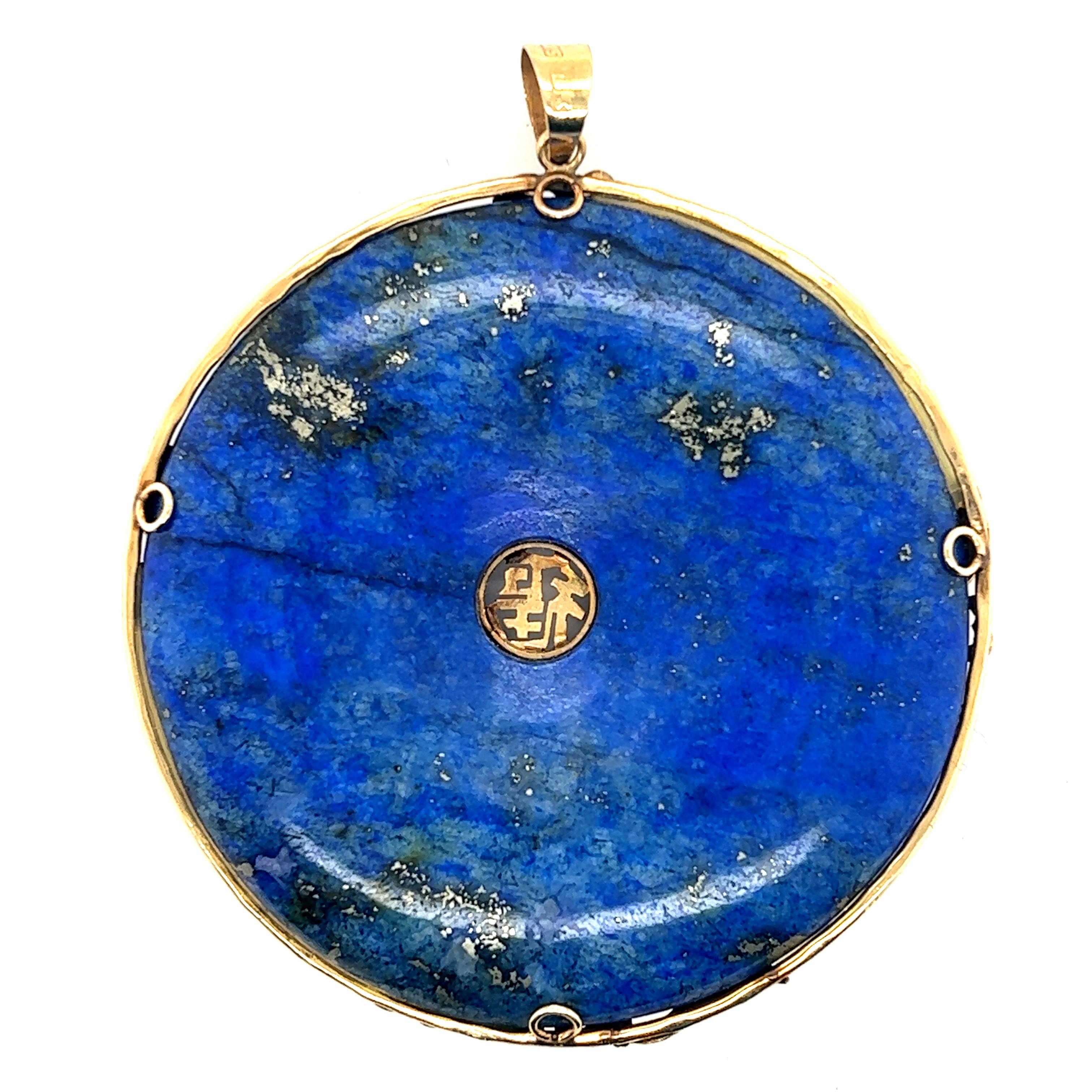 Fabulous pendant crafted in 14k yellow gold encasing one large donut shaped Lapis Lazuli gemstone. The pendant is finely encased in luscious 14k yellow gold with butterfly patterns highlighting the edges.  The butterfly's seem to float amongst the