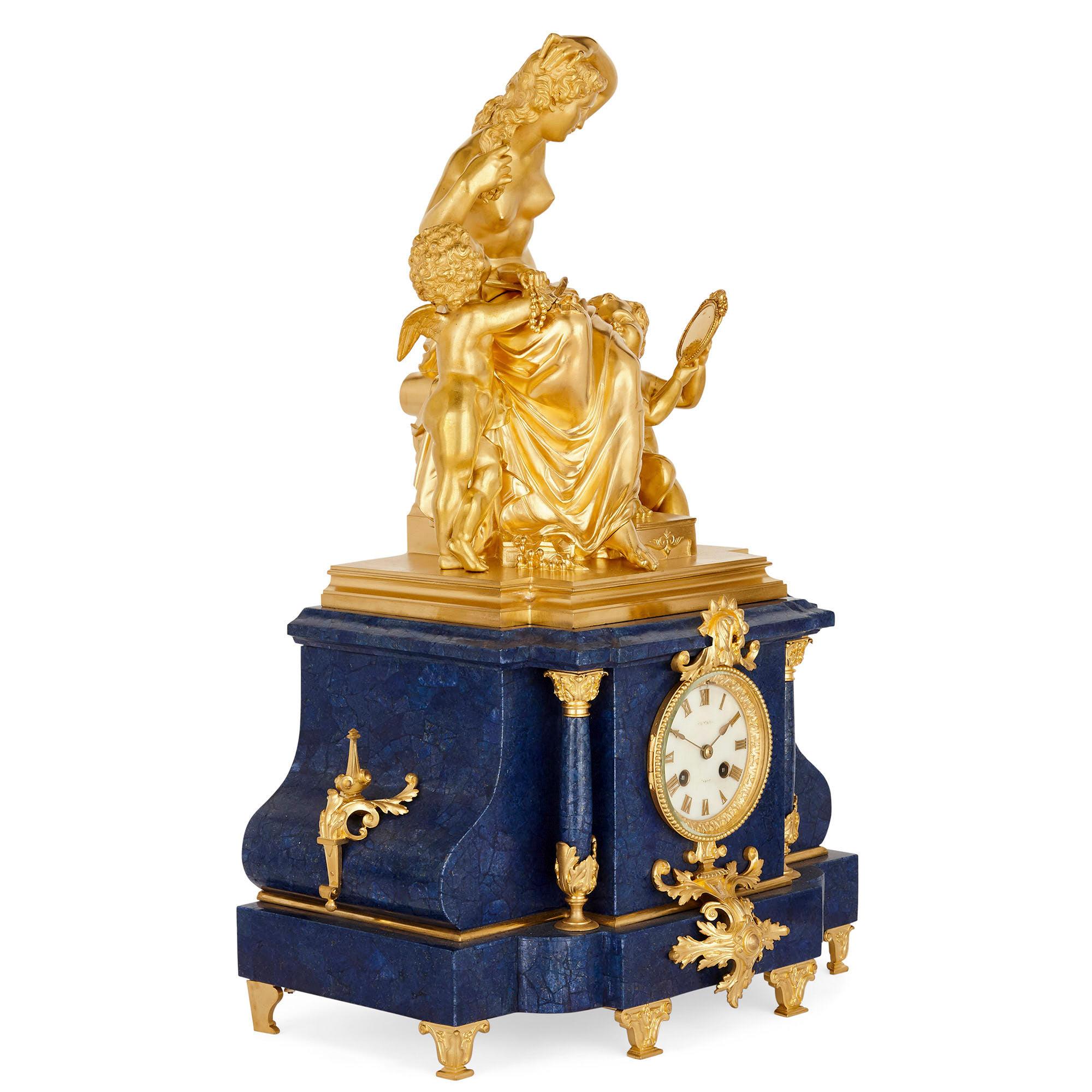 This set three-piece garniture contains a mantel clock and a pair of conforming flanking vases. The set is wrought from gilt bronze, painted porcelain, and lapis lazuli—the lapis a later addition.

The central mantel clock is strikingly designed: