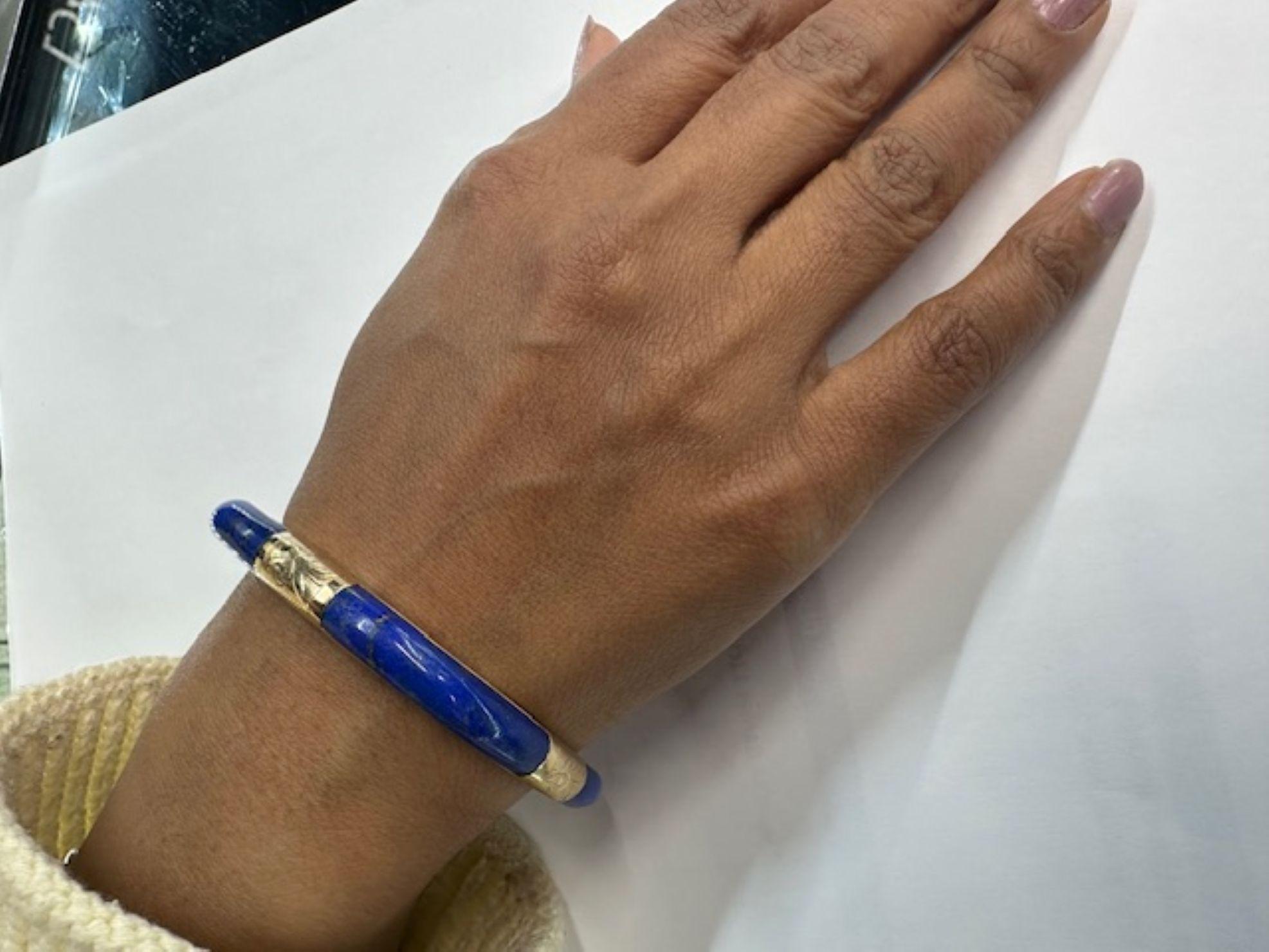 Interesting abstract 1970s bracelet in a square design features 4 perfectly matched polished pieces of Lapis Lazuli spaced by finely engraved gold elements. A chic and most wearable piece of vintage jewelry. Inner circumference 6.75 inches.