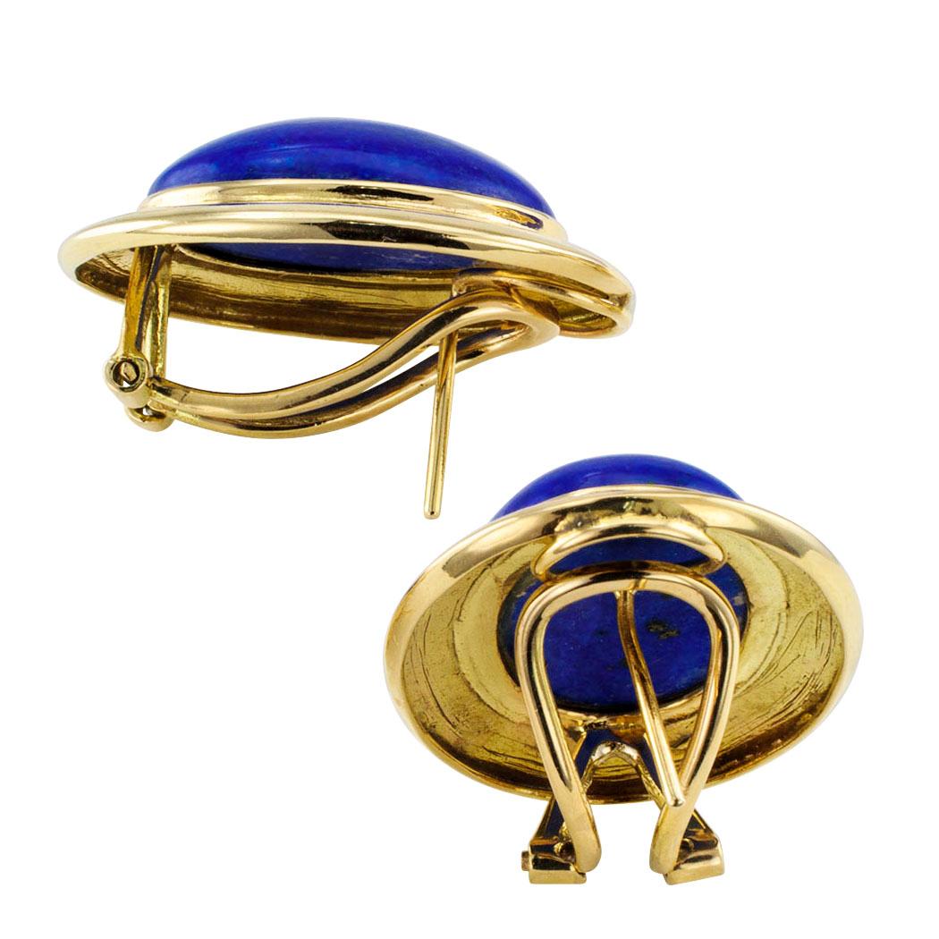 Estate 1980s lapis lazuli and gold button earrings. Featuring a pair of matching lapis lazuli cabochons set in conforming bezels of shiny 14-karat yellow gold, fitted with omega with post backs. This is a smart looking pair of lapis lazuli earrings