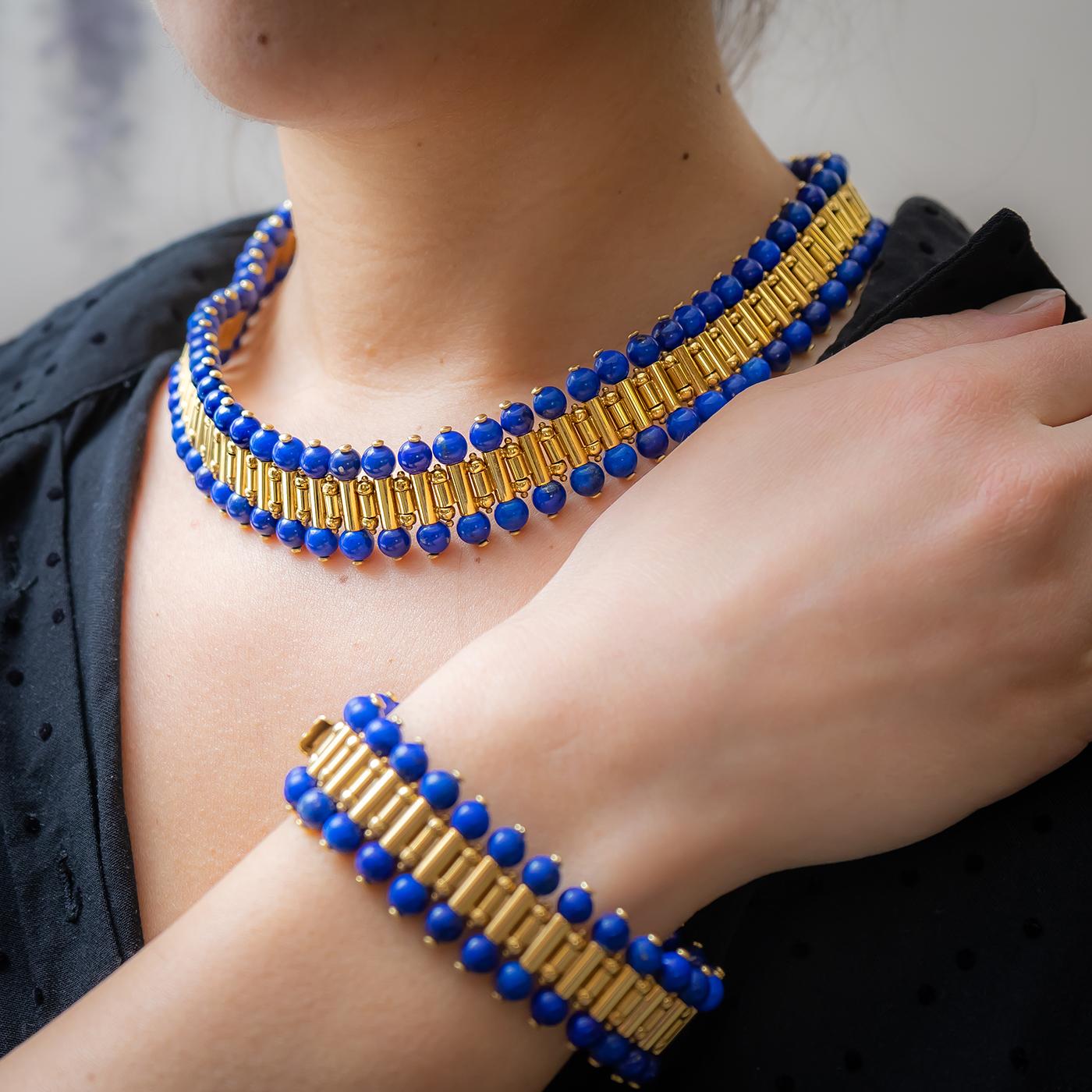 A mid 20th century, French, gold and lapis lazuli bead necklace and bracelet suite with an articulated design of tubular links, with a lapis lazuli bead at each end, mounted in 18ct gold, with French eagle marks.
Necklace length 44cm
Bracelet length