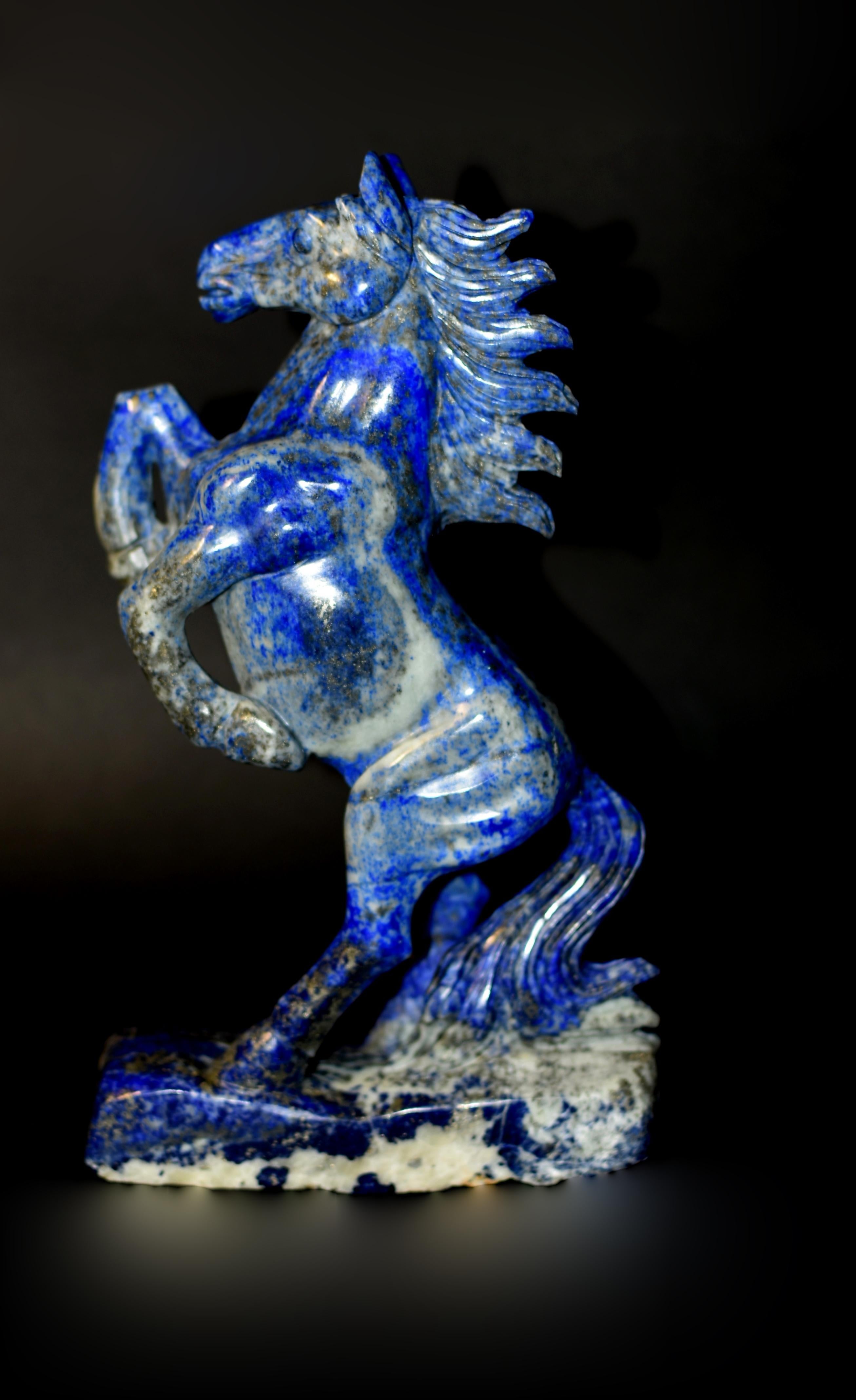 Crafted by a Chinese master carver, using the finest grade, all-natural lapis lazuli sourced from the mines of Afghanistan, this amazing sculpture captures the essence of motion, strength, and majestic beauty in a single form. The horse, frozen in a