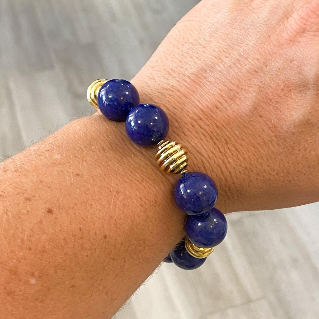 Bold in size and rich in color, these large lapis lazuli beads are 10.5 mm in size and accented with 18 karat yellow gold beads on this fabulously versatile bracelet. The large size makes a statement that looks wonderful whether you're dressing up