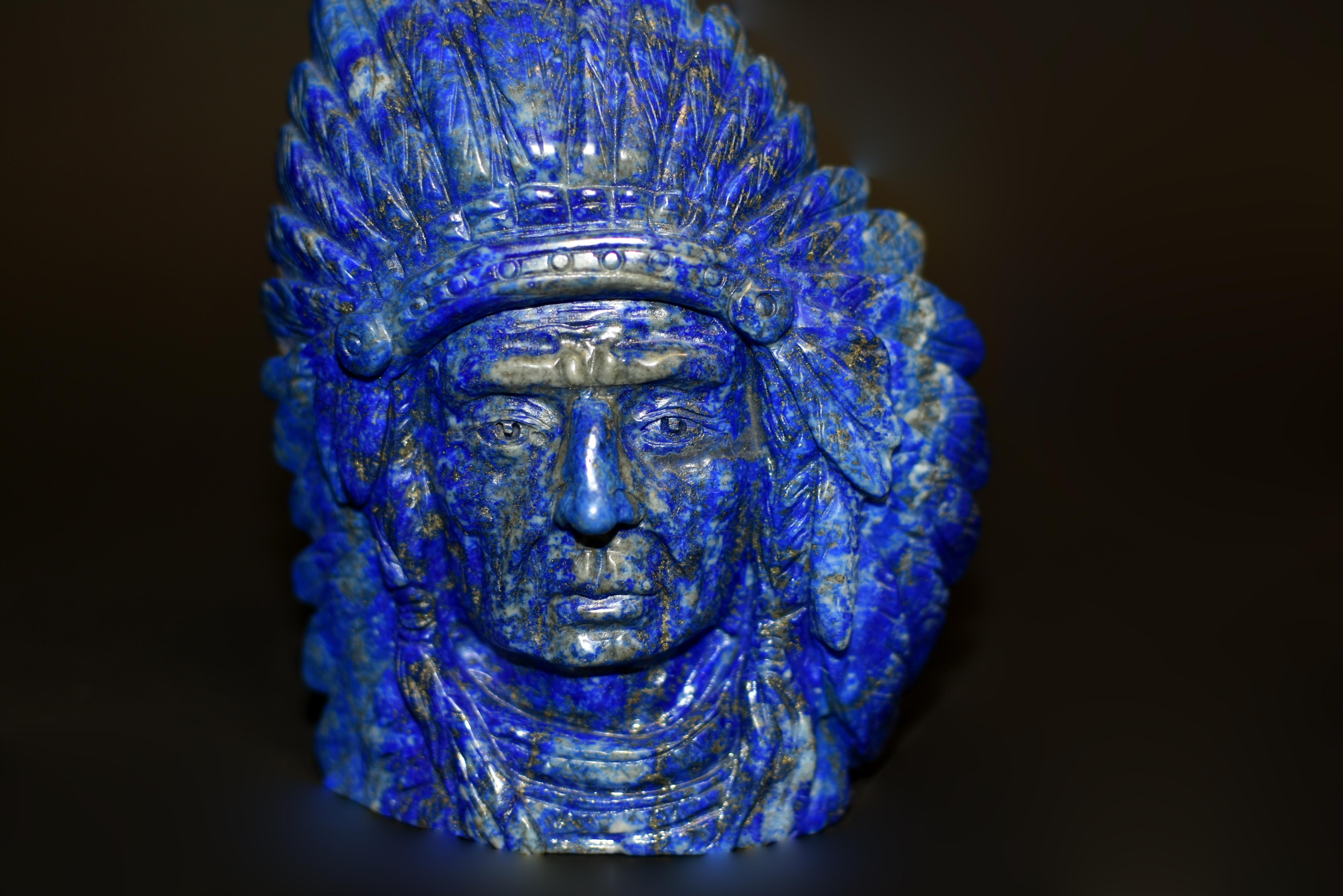 We discovered, and through extraordinary efforts acquired this rare lapis lazuli Indian chief statue, capturing the essence of a Native American leader adorned in his magnificent feathered headdress. Crafted with meticulous attention to detail, the