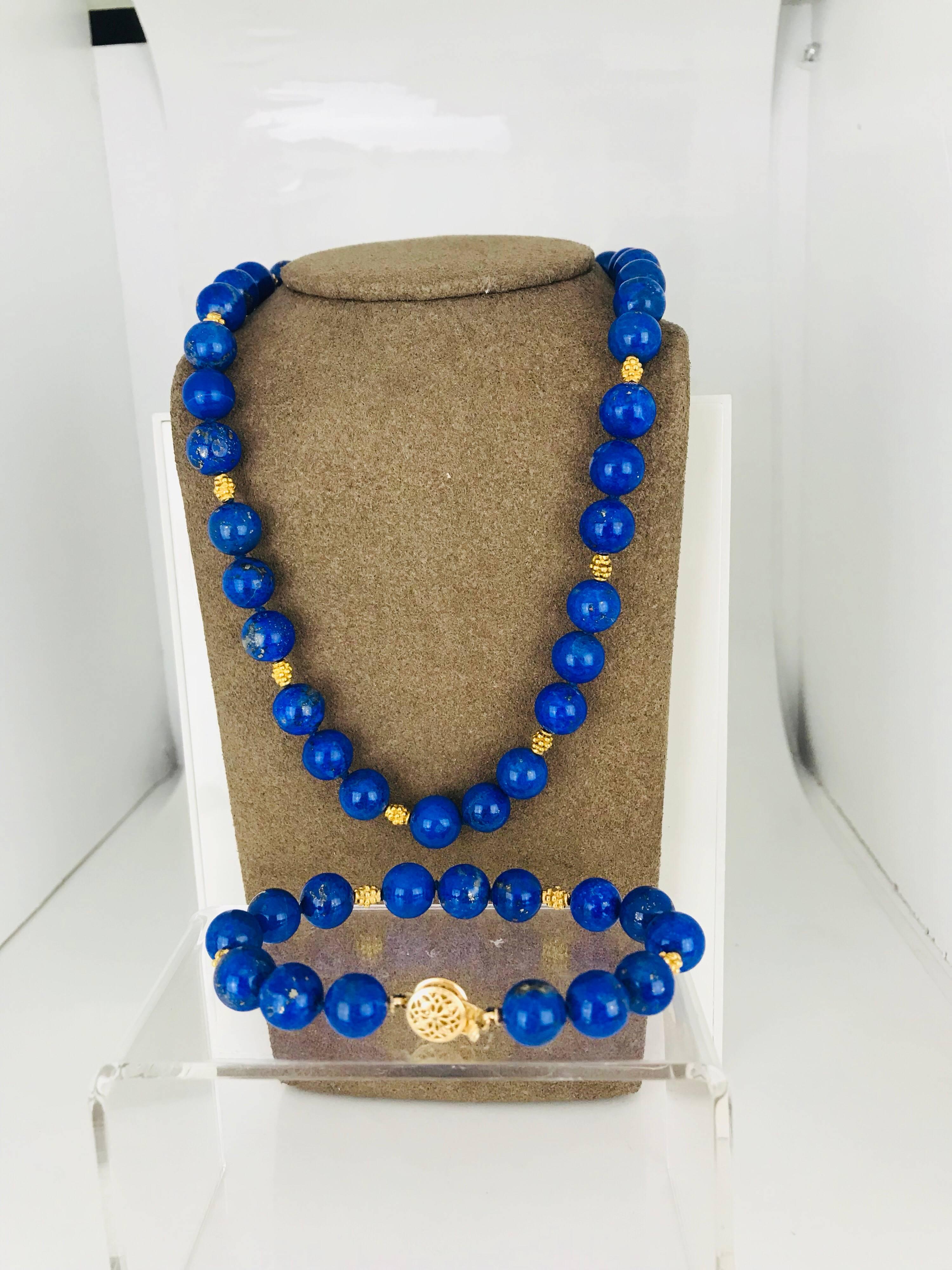 Contemporary, matching Necklace and Bracelet made of Lapis Lazui 9.65 millimeter and 14 karat yellow gold accents. 
The necklace is 16 inches in length
The bracelet is 7 1/4 inches in length
Rich Blue Color.

GIA Gemologist, Inspected and Evaluated
