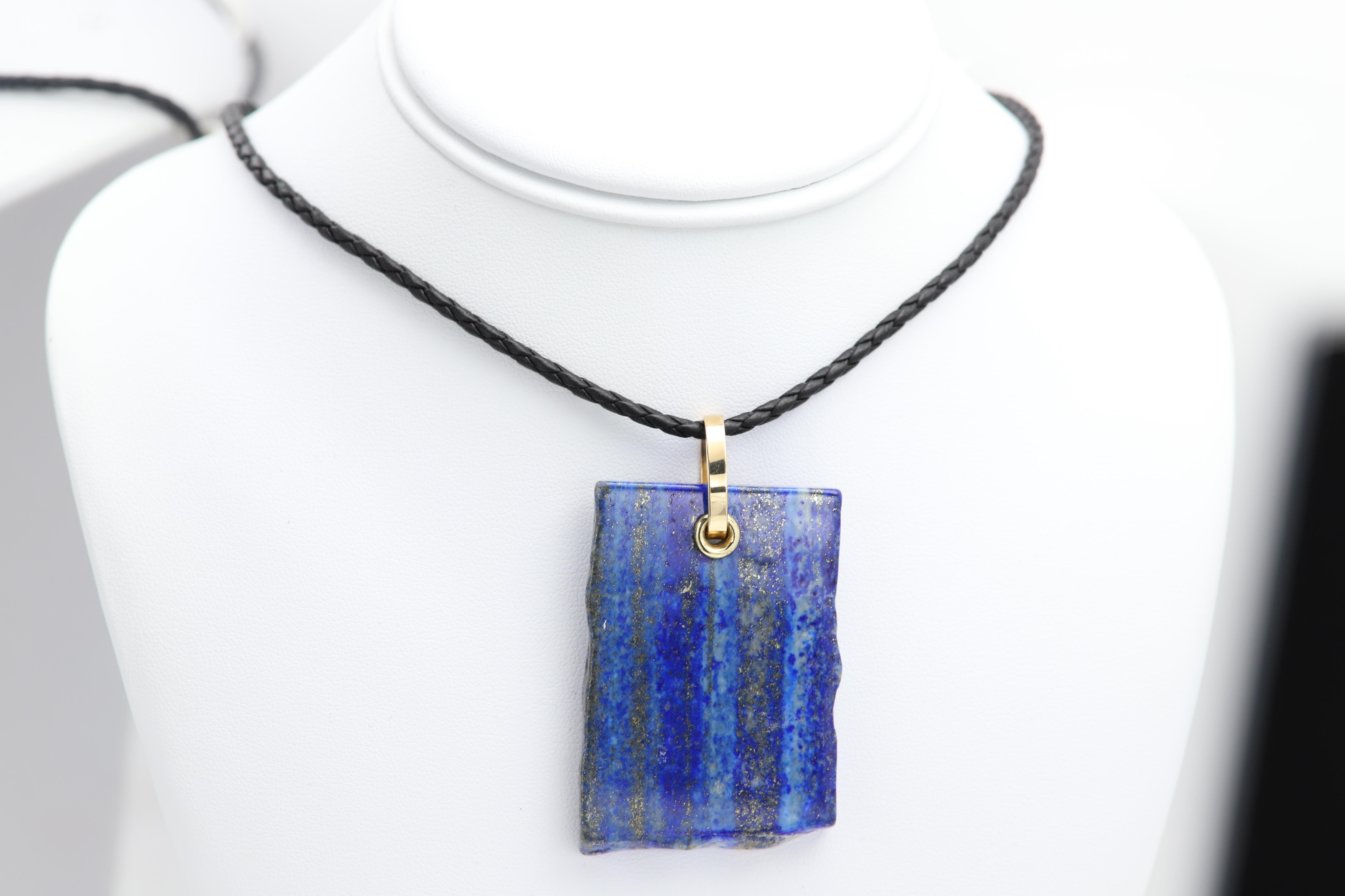 Natural Stone Necklace
Brilliant Blue Colors
Set with real 14k Gold parts
Stone Type: Natural Lapis Lazuli
Size: approx 50 x 35 mm (2' x 1.4' inch)
Leather cord Italian made - adjustable length 15.5-17.5' Inch
Cord has Sterling Silver