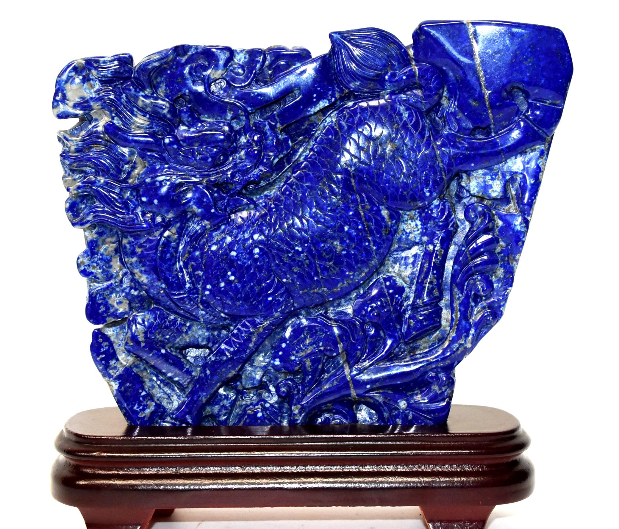 A beautiful all natural 1st grade lapis lazuli Qi Lin sculpture. The gorgeous blue stone has stunning glittering of gold and white snow scatters, a contrast that creates wonderful visual effect. Fantastic carving work shows off the Qi Lin's scales